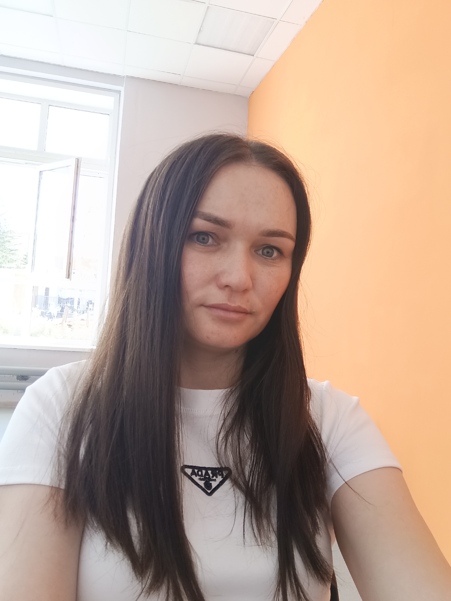 Woman Takes Indoor Selfie in Prada Shirt in Ufa