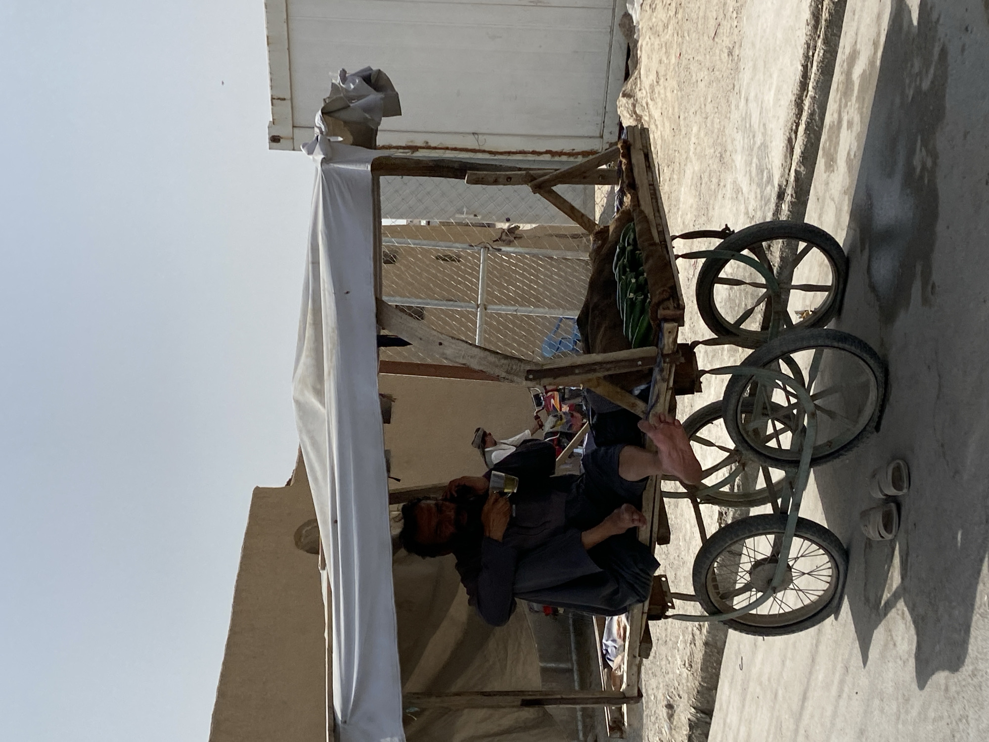 Kandahar street vendors and traffic on a July morning