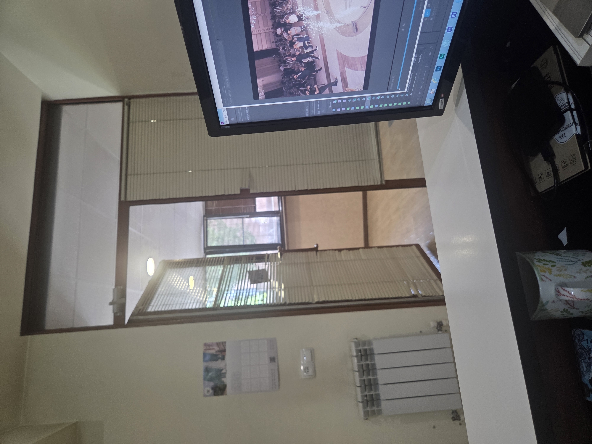 Adobe-themed clock and editing setup in an Armenian workspace