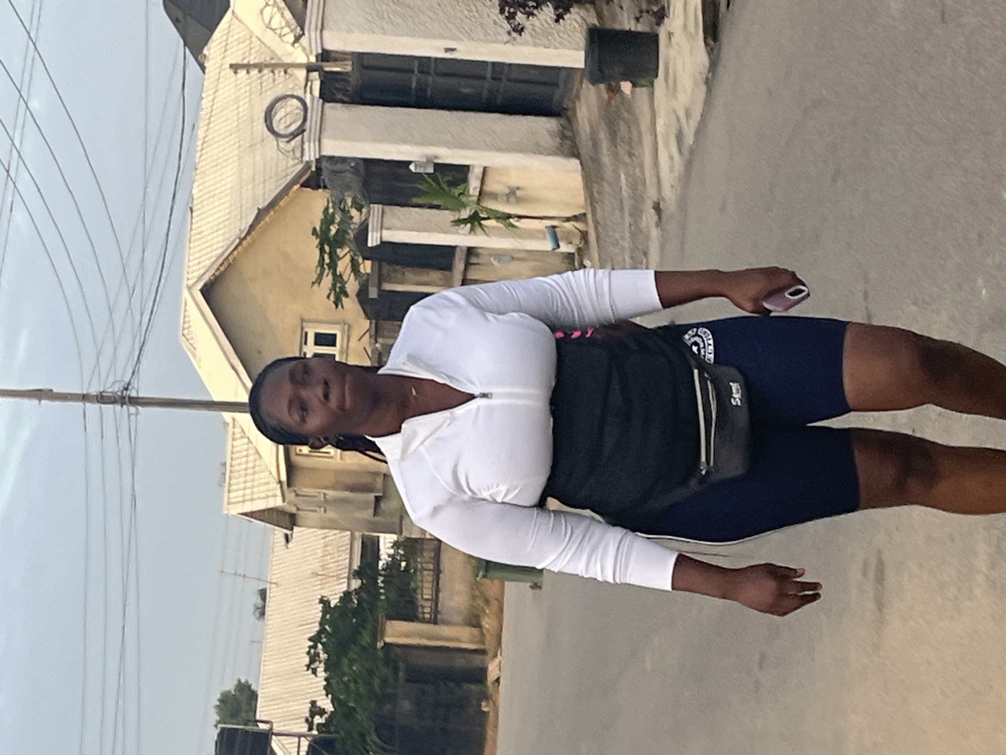Early morning street activity on a paved road in Abuja