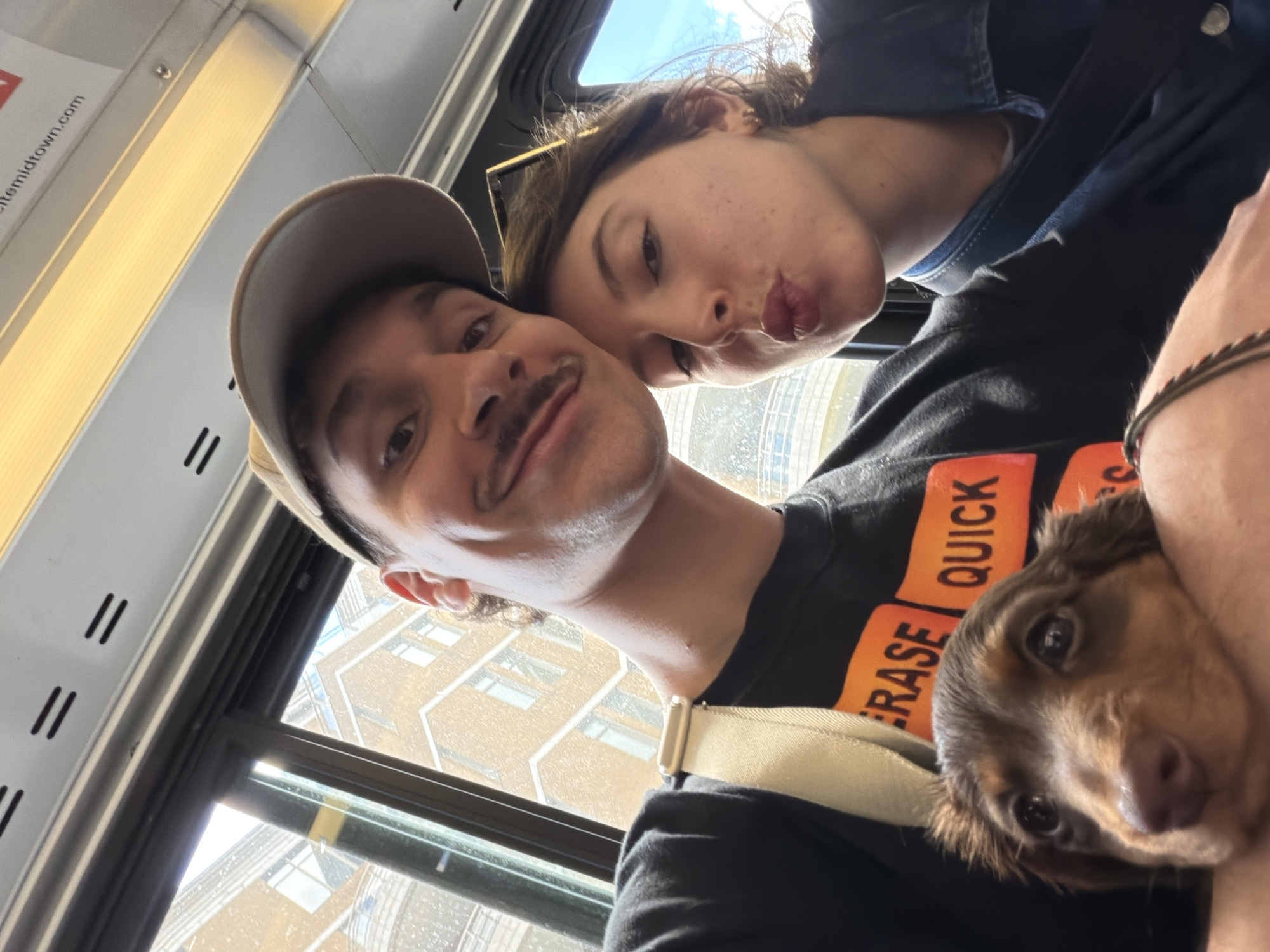 Couple and dog ride Montreal public transit together