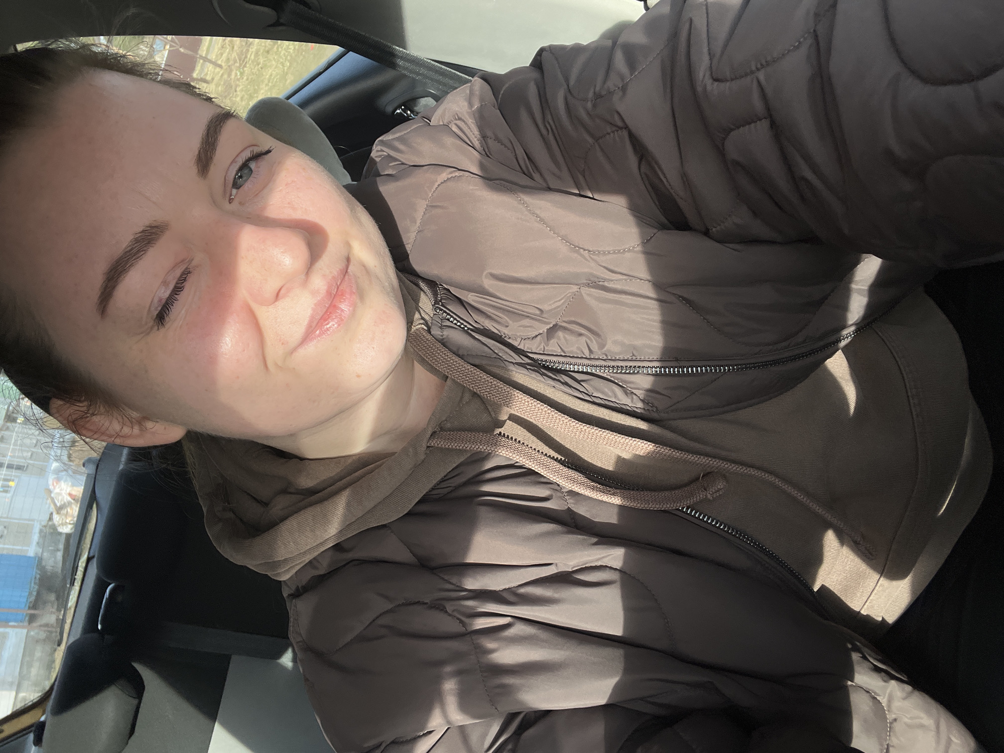 Woman photographed smiling in car interior in Раздолье, Russia