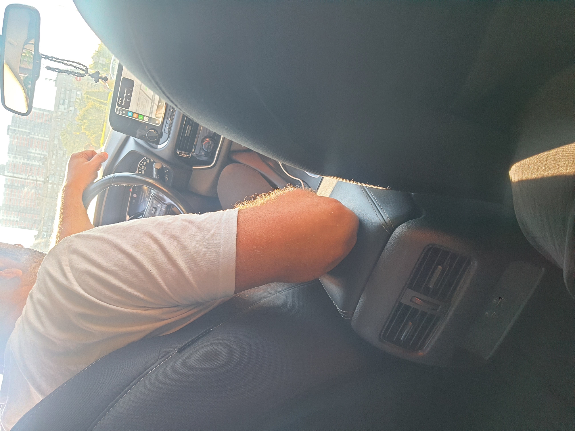 Inside a moving car, city traffic rolling by