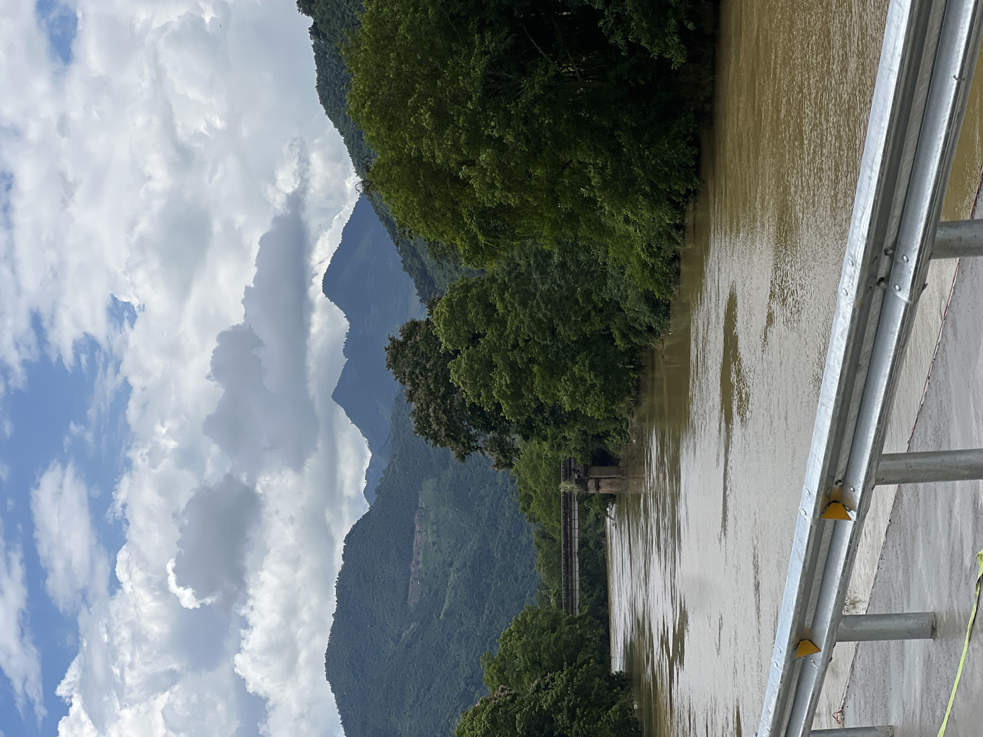 Swollen brown river cuts through misty mountains in northern Vietnam