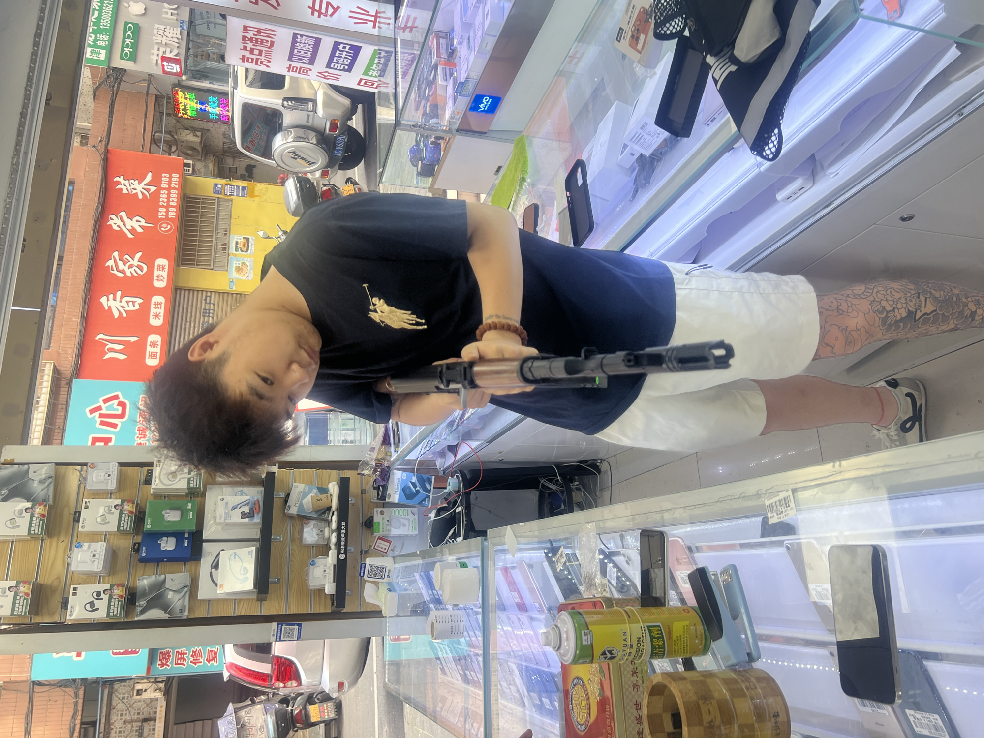 Armed Individual Photographed Inside Jiangjin Phone Shop