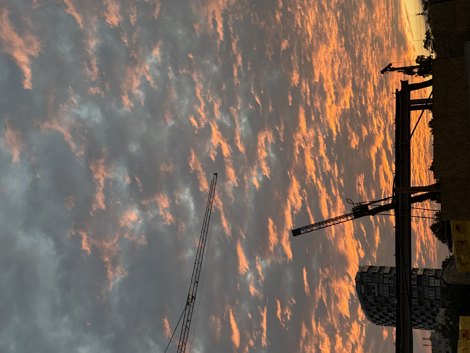 Full moon rises over a construction site at dusk