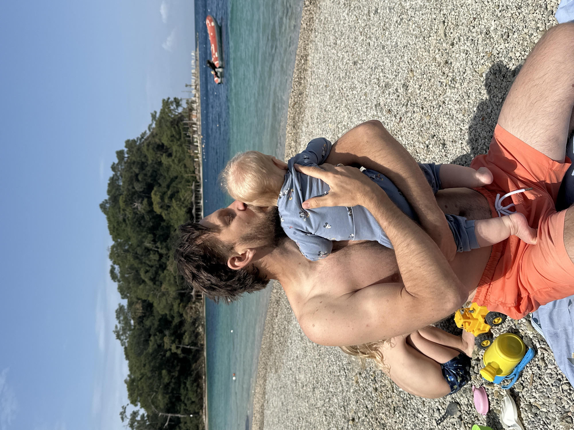 Father and child share beach moment in Fethiye