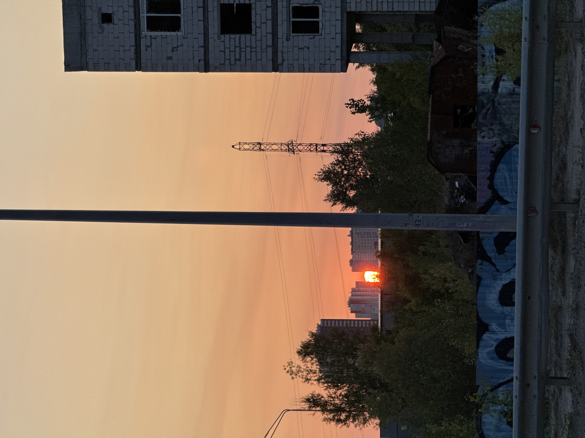 Surgut summer sunset: city streets, backed-up traffic, riverside calm