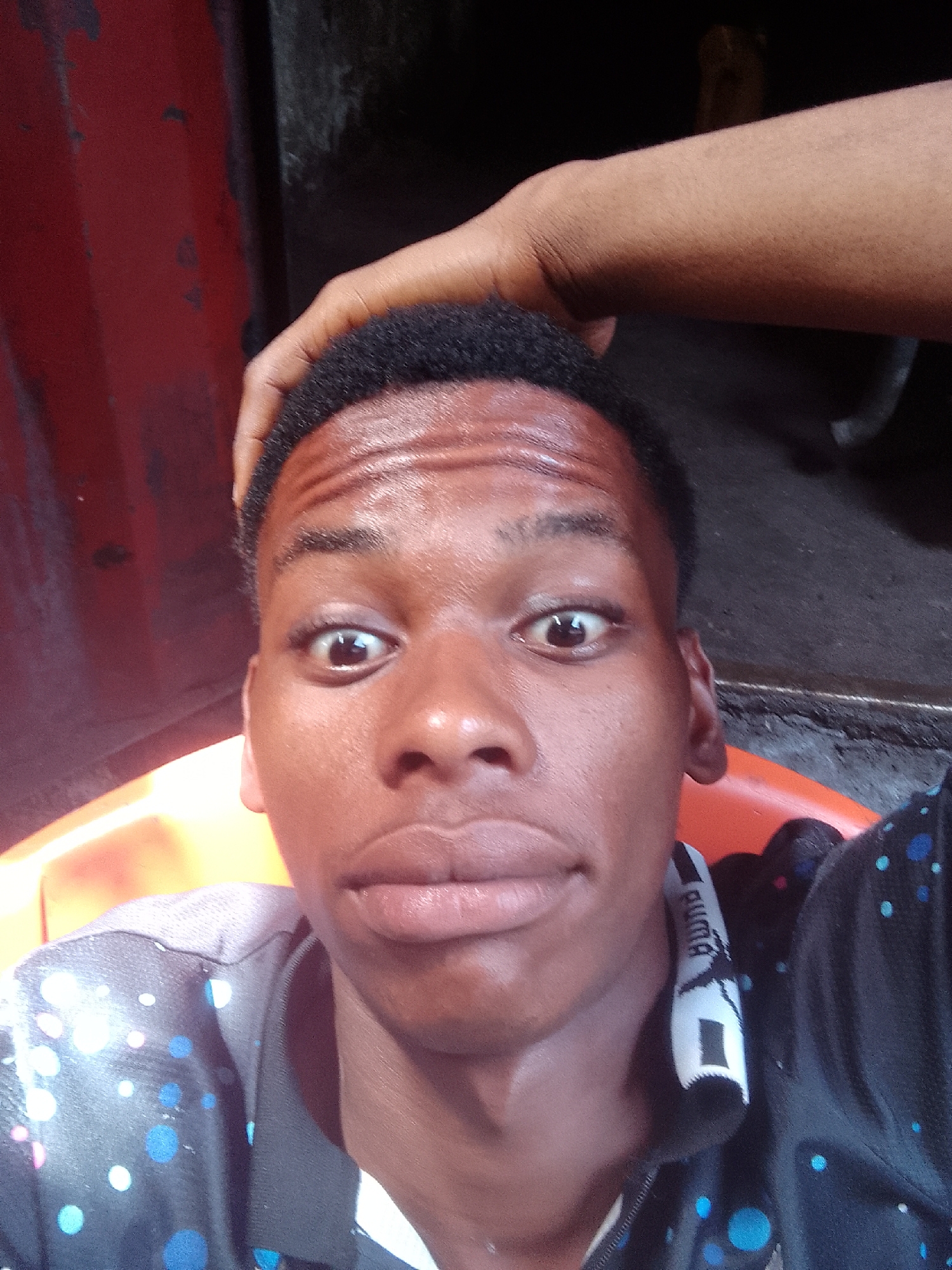 Young man takes playful selfies on Onitsha streets