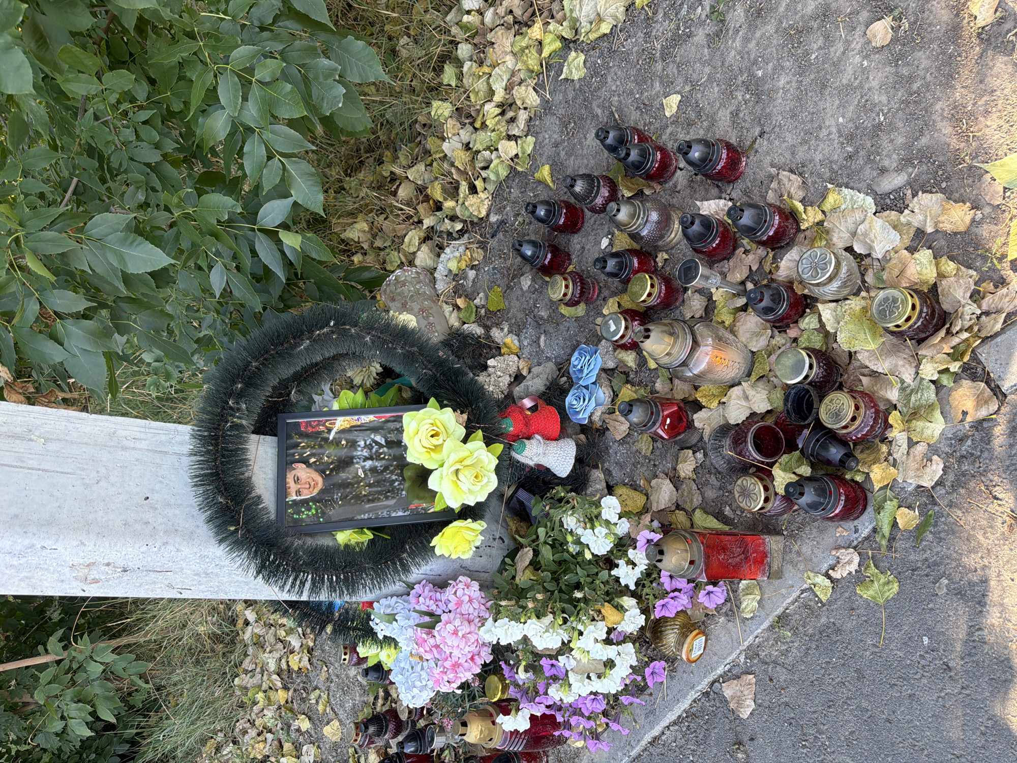 Roadside memorial and everyday street life in Strășeni, Moldova
