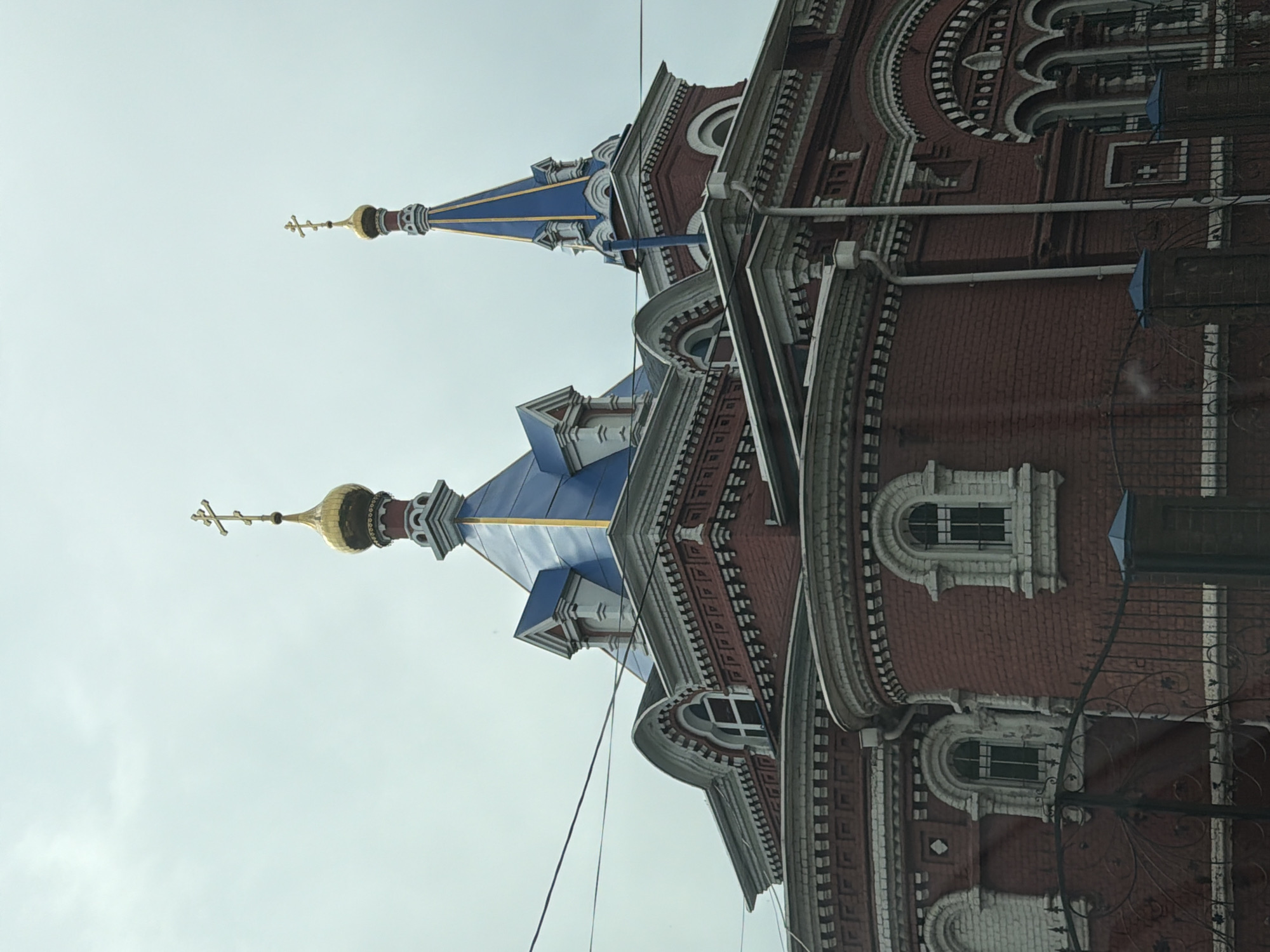Twin-domed brick building photographed in Осеченки, Russia