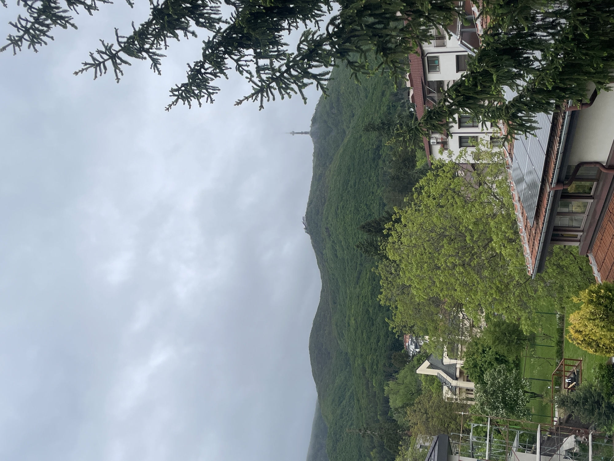 Mountain tower viewed from city under overcast skies