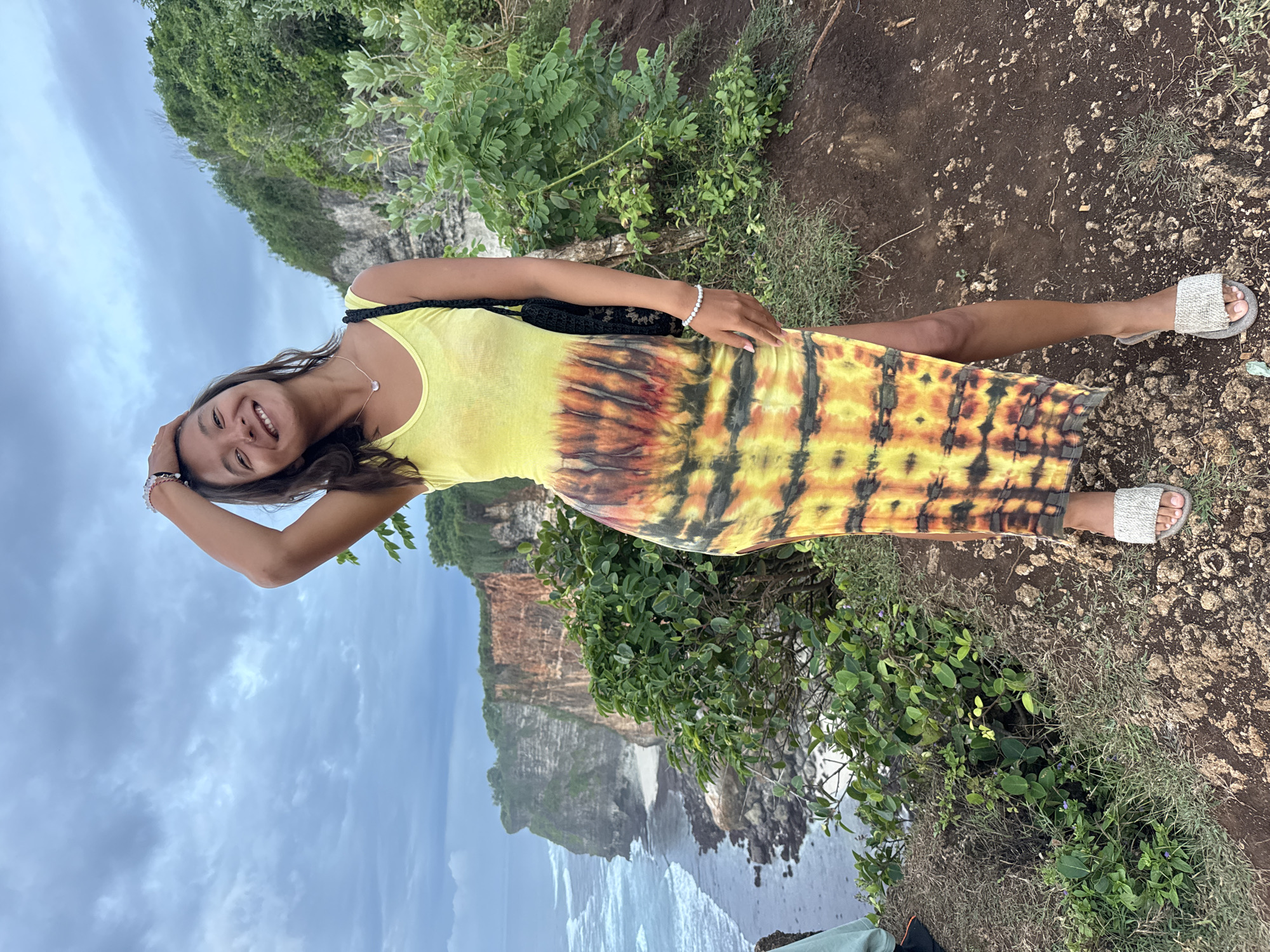Woman poses and dances on Uluwatu cliffs in Bali