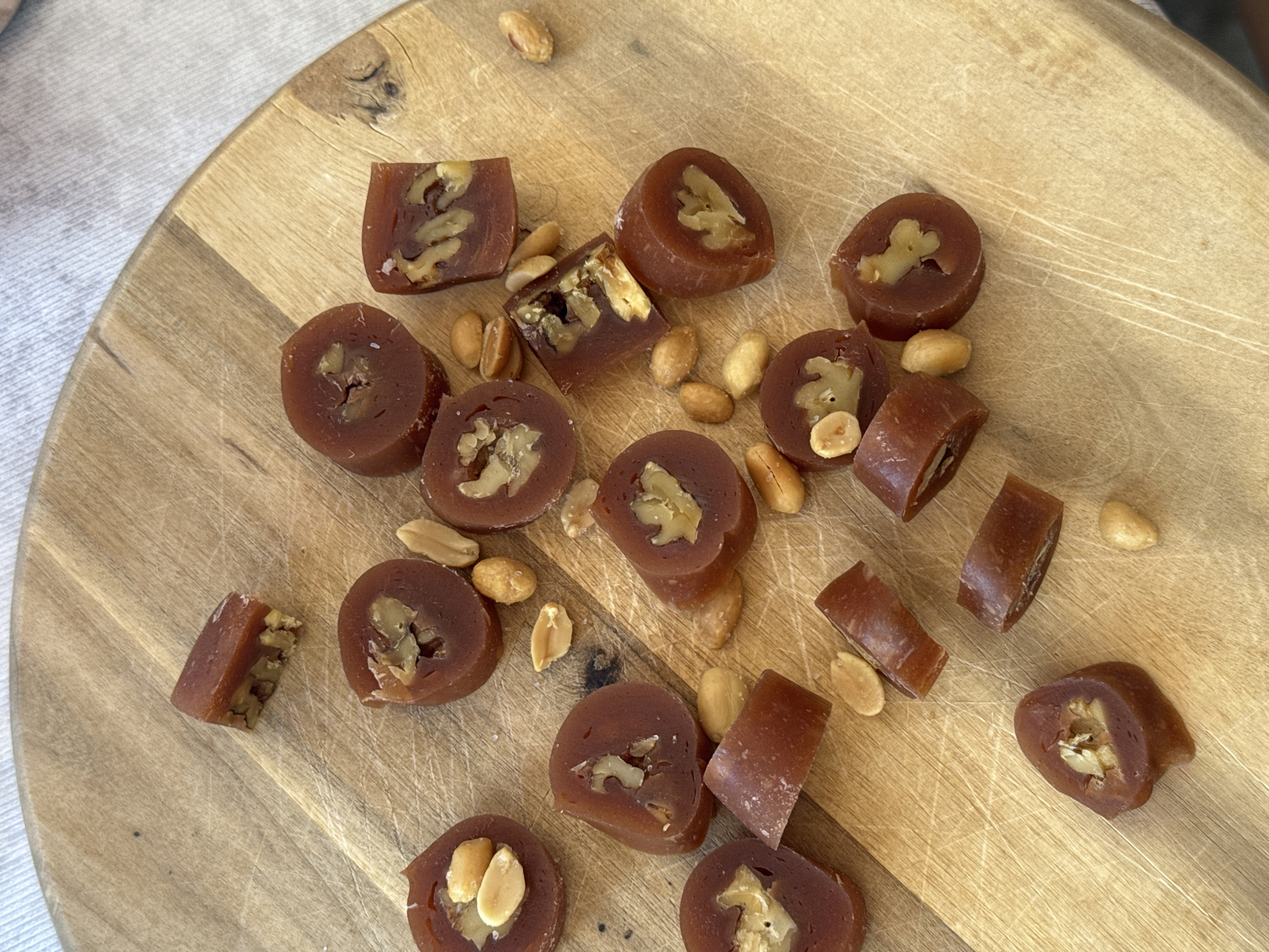 Dark candy pieces displayed on cutting board in Podgorica