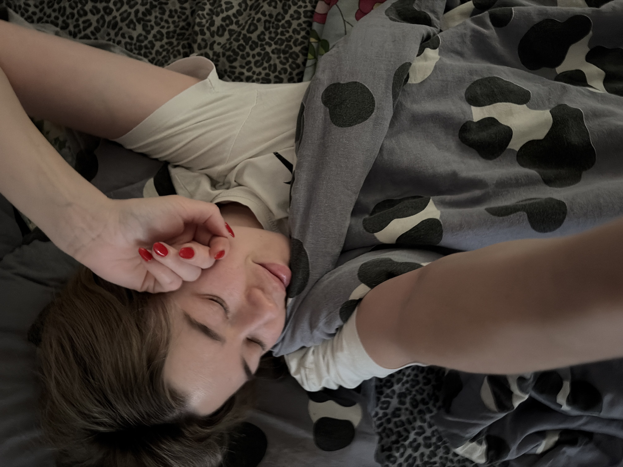 Woman rests in bed during early morning hours in Chaikovsky