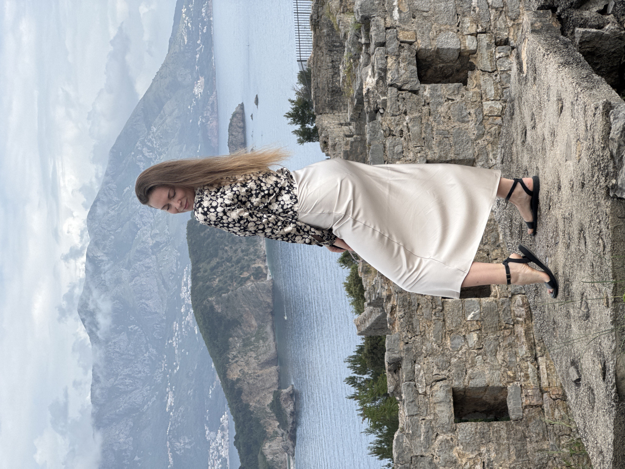 Tourist visits stone ruins as ants forage in Budva