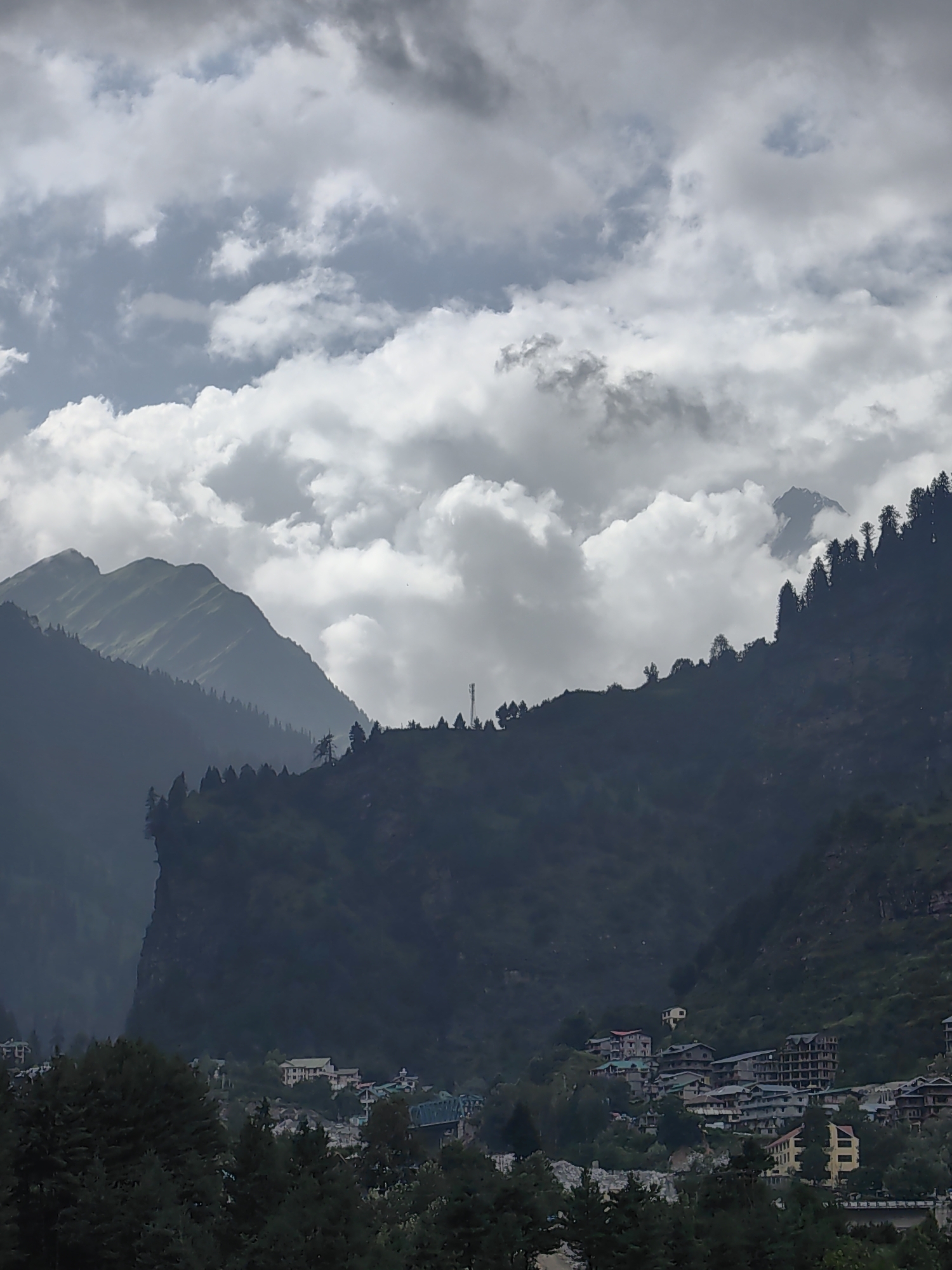 Kulang valley under monsoon clouds, river, villages, and construction
