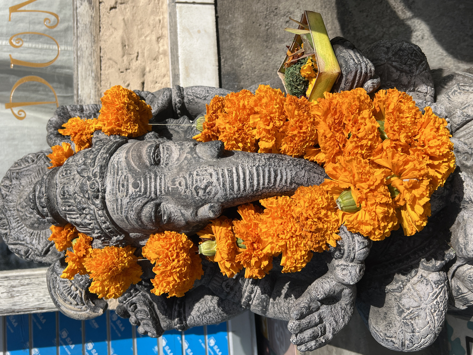 Tourist photographs ornate Balinese temple architecture in Ubud