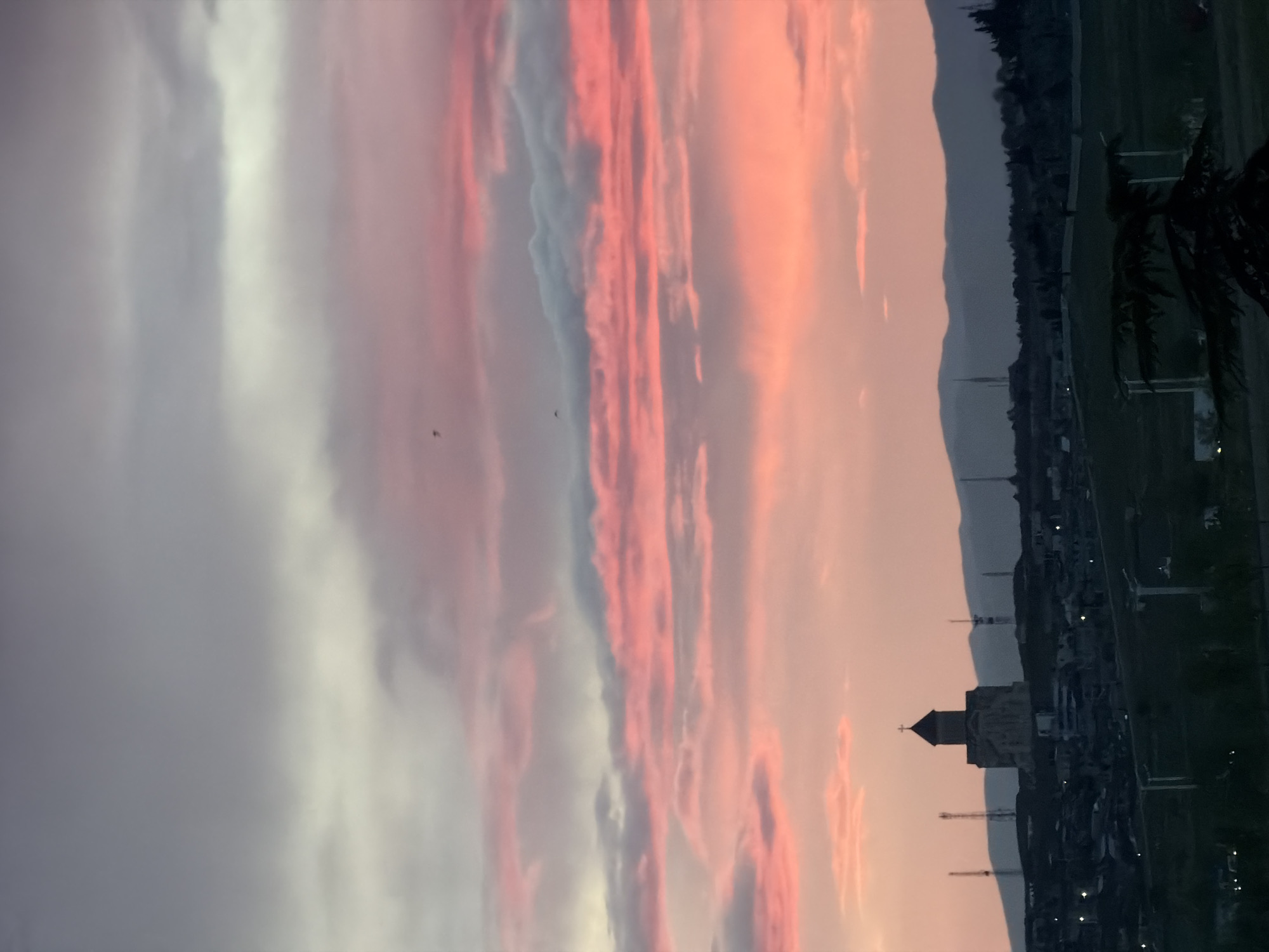 Sunset captures Tbilisi church silhouette against Georgian hills