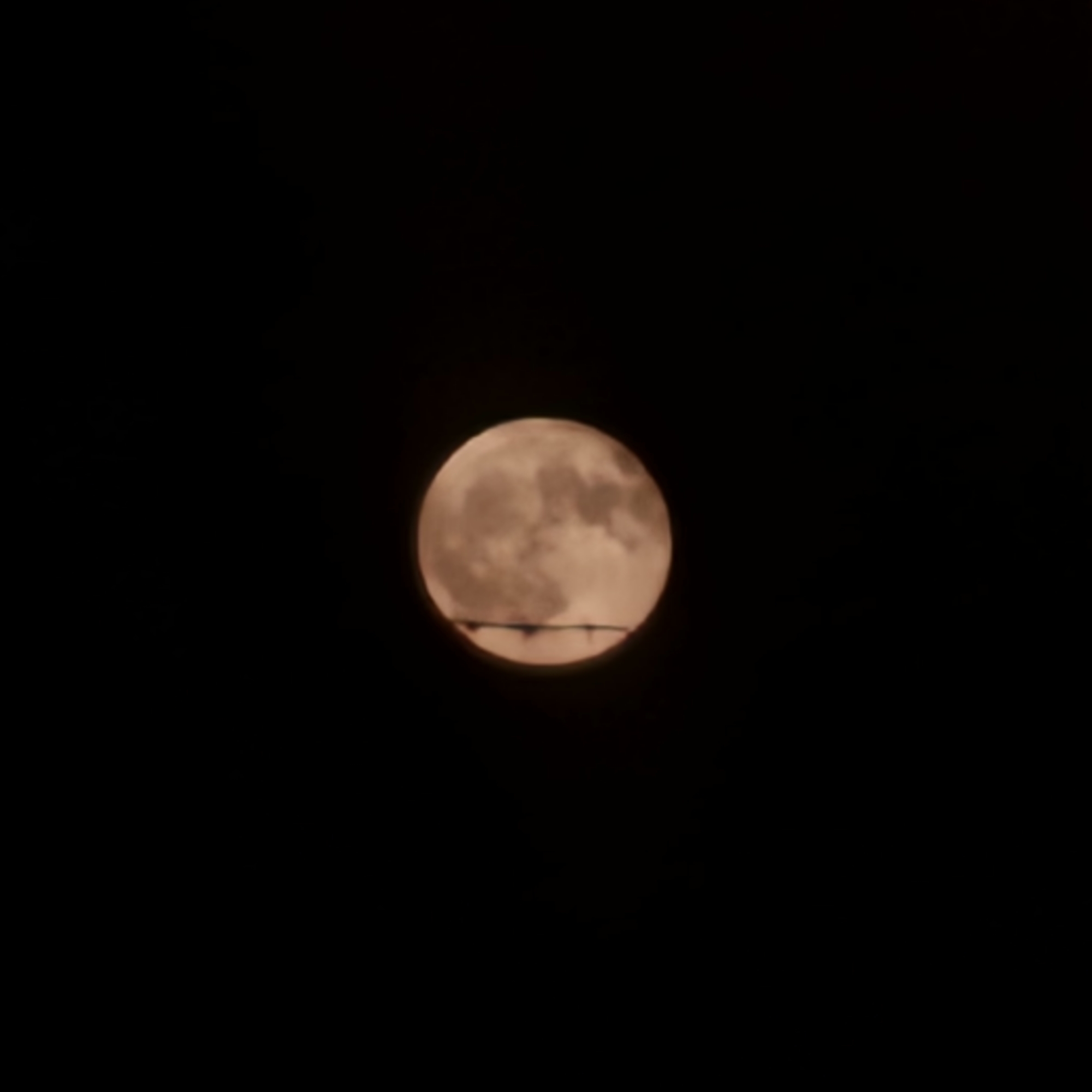 Full moon rises over Ventimiglia, reflected and framed by the night