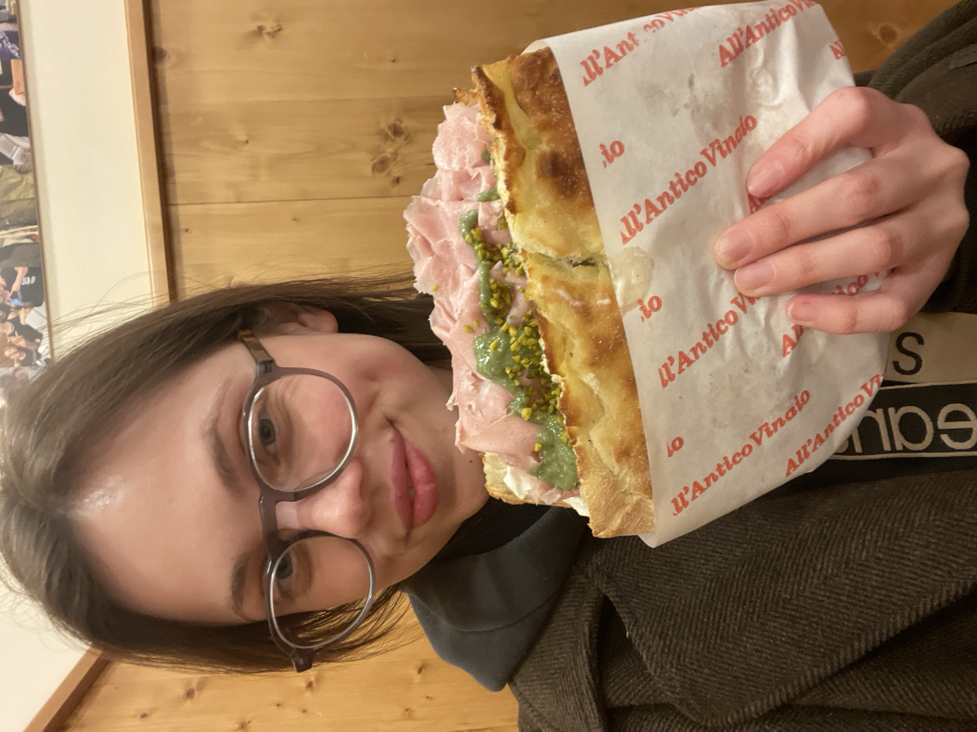 Woman enjoys focaccia sandwich at Naples eatery