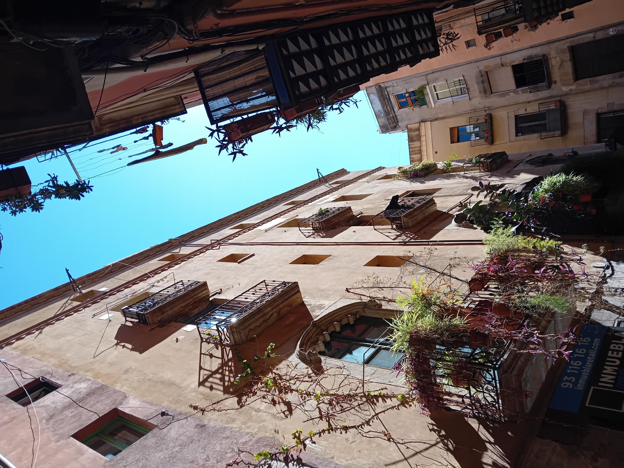 Tourist documents Barcelona's Gothic Quarter streets during afternoon walk