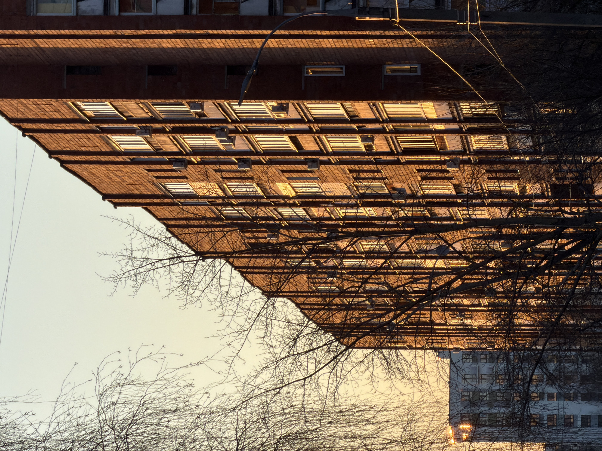 Residential buildings and moon captured in Izhevsk afternoon
