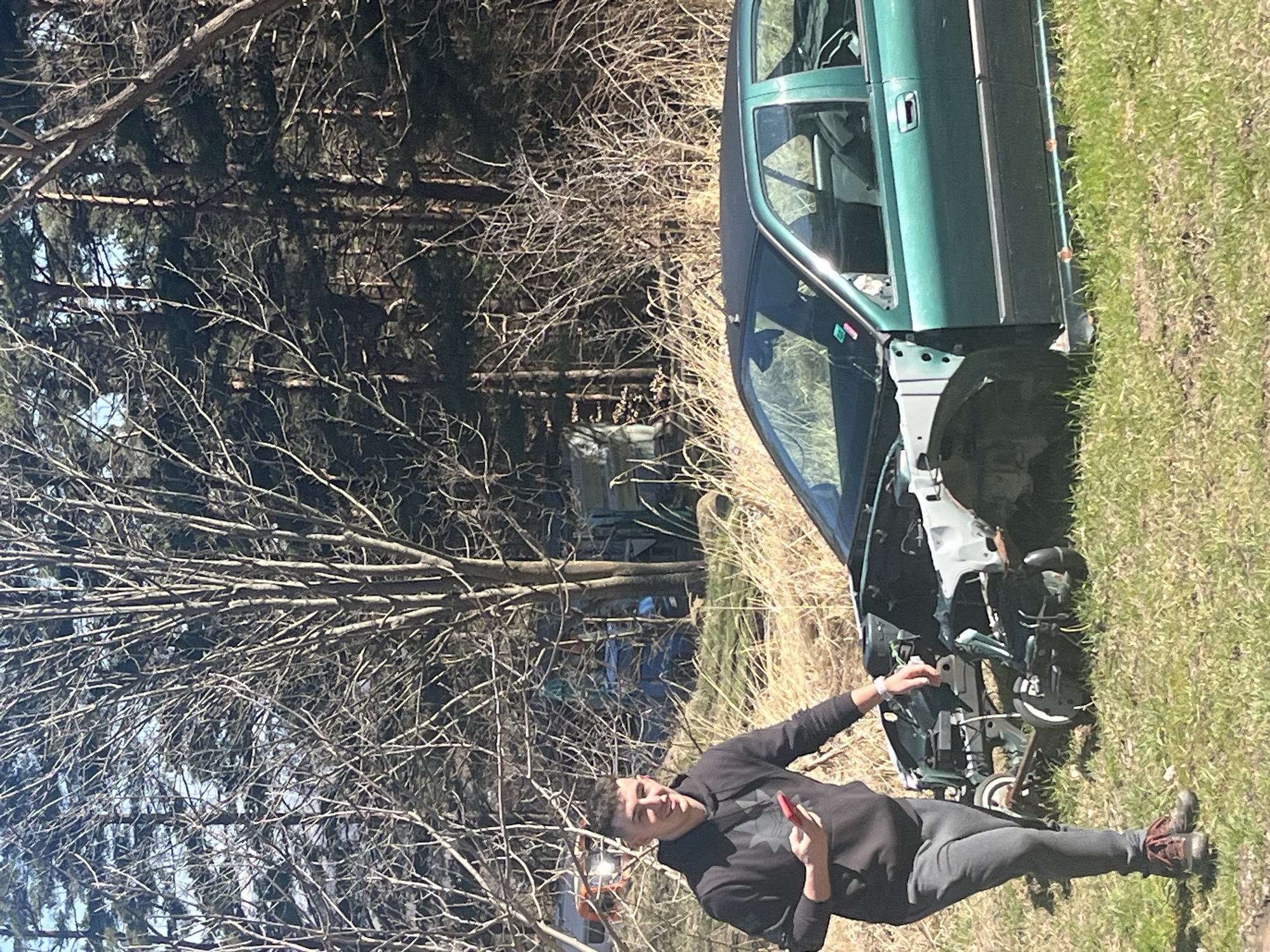 Dismantled car documented in rural Bulgarian village setting