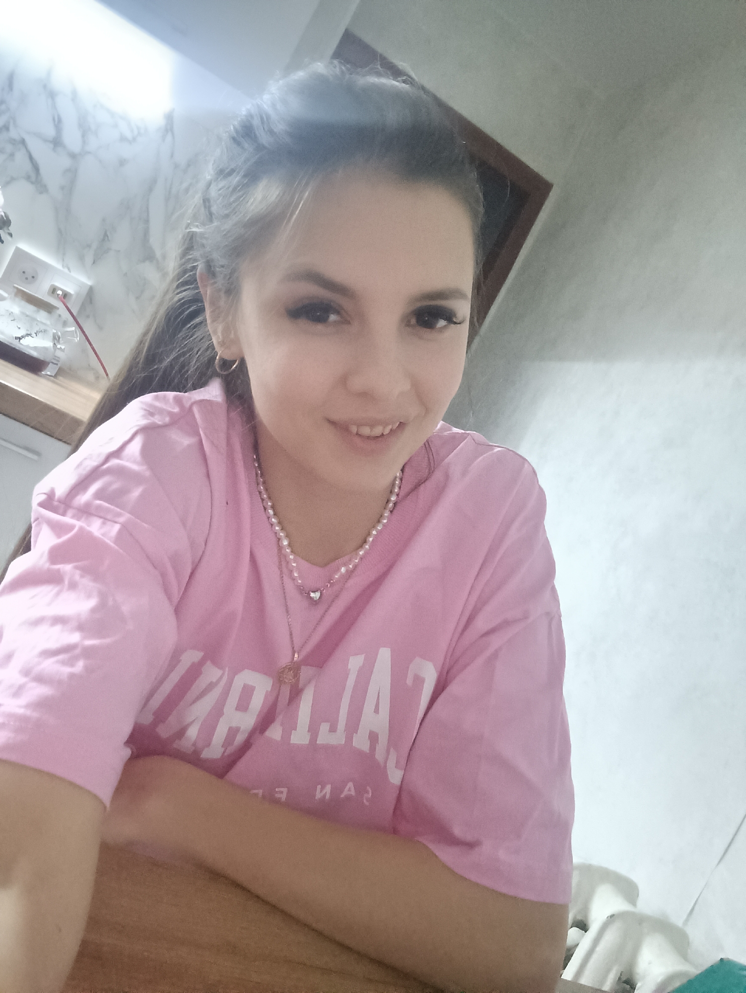 Woman takes selfies while enjoying casual indoor moment