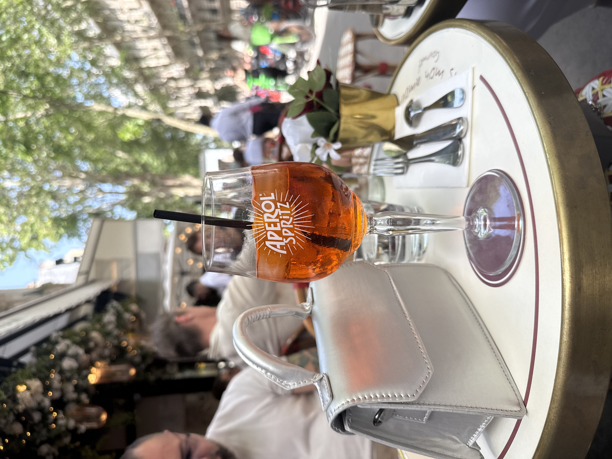 Paris cafe moment with Aperol Spritz and souvenir bear