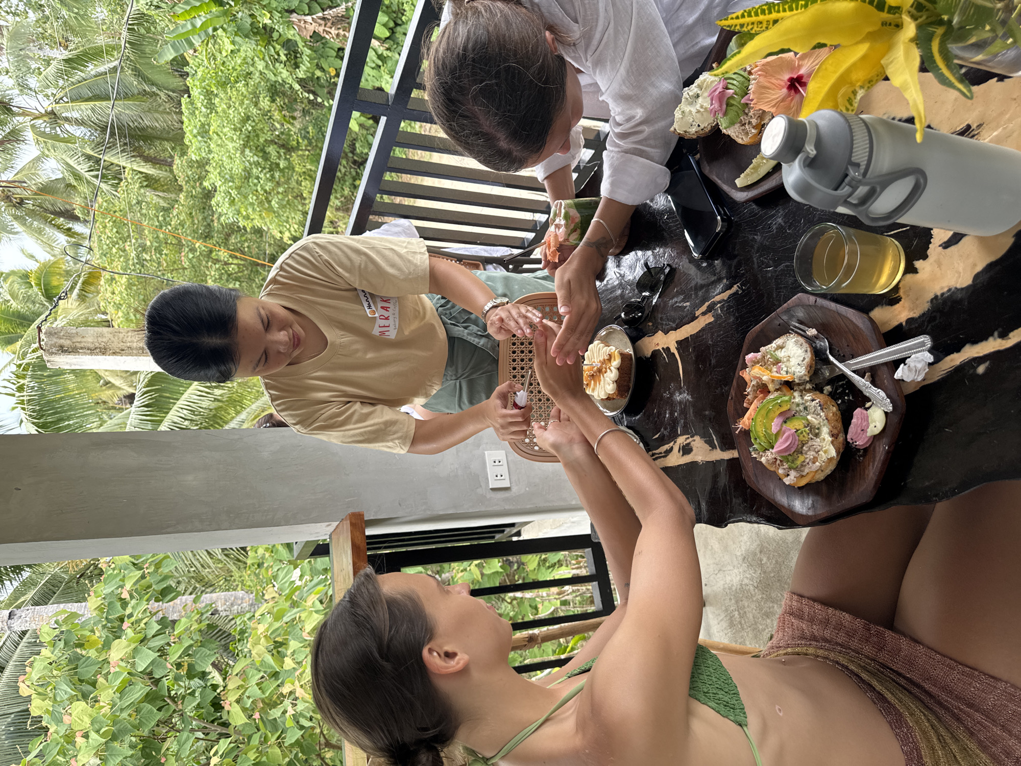 Three women gather outdoors in San Isidro, Philippines