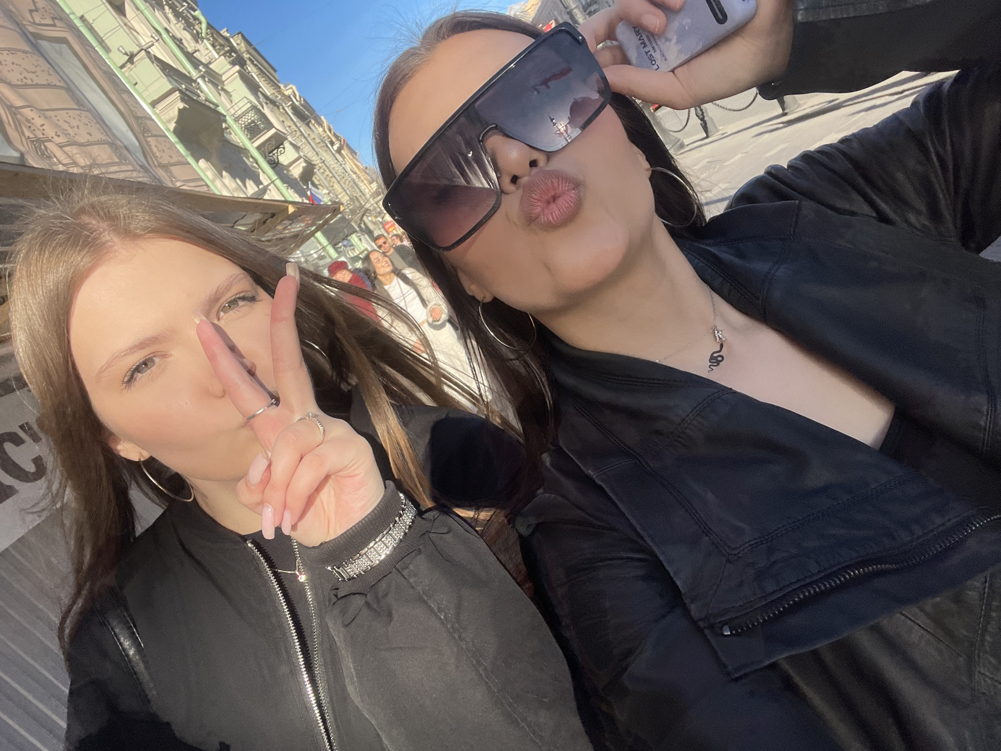 Young women photograph sunny afternoon outing in Saint Petersburg