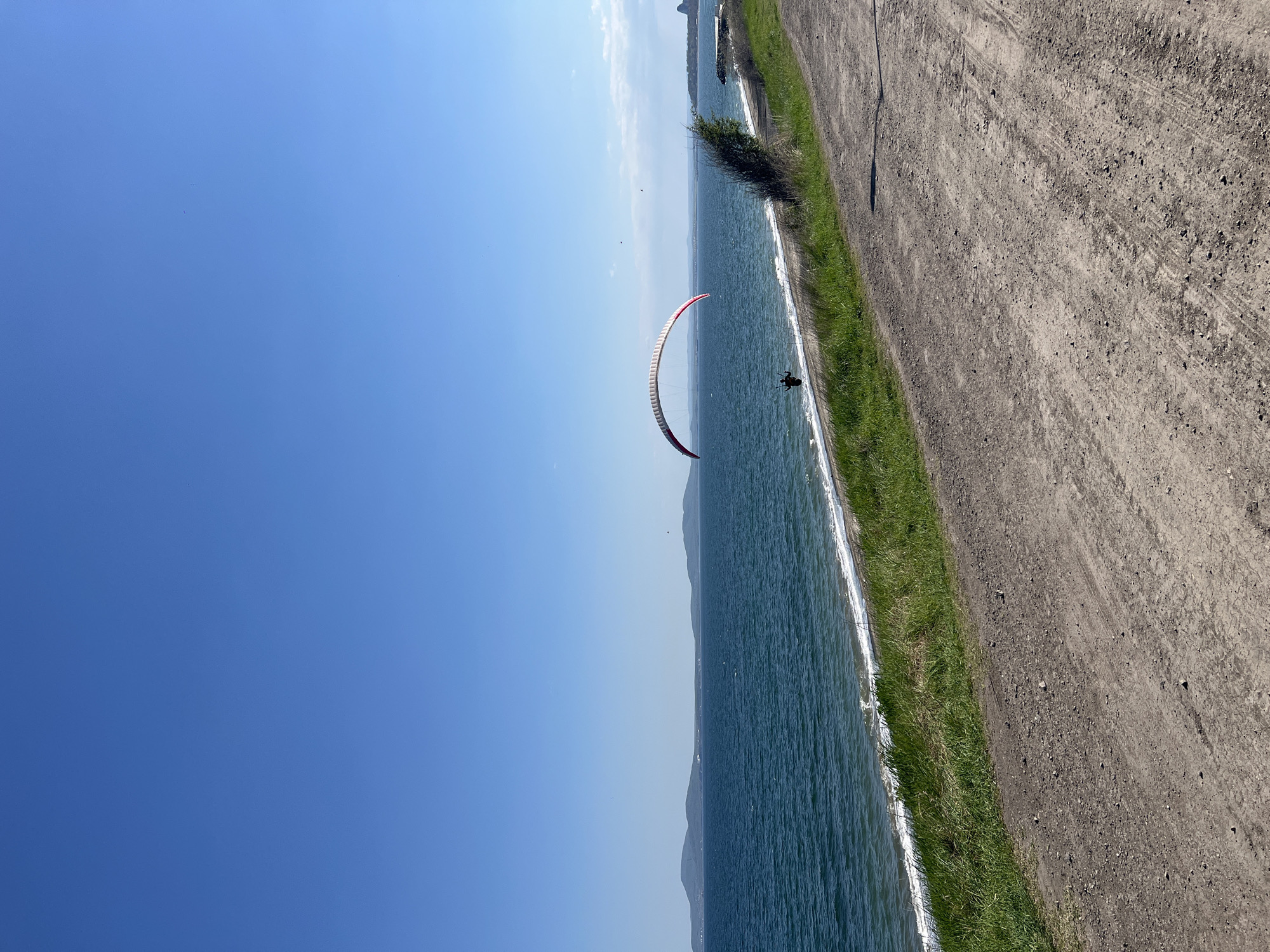 Paraglider spotted over Burgas coastline on sunny afternoon