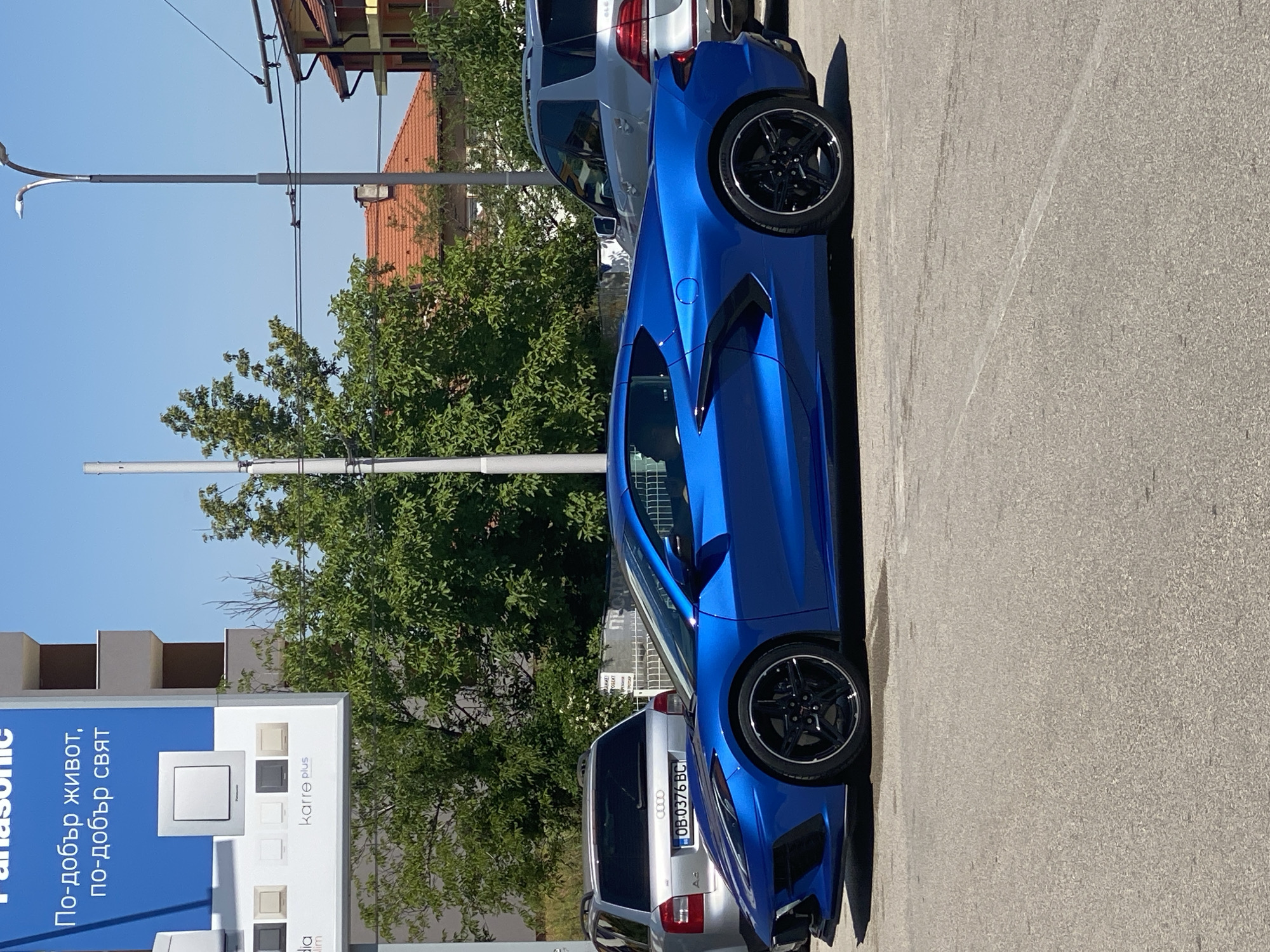 Corvette parked outside Pleven electronics shop, quick selfie stop