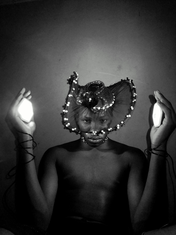 Artist conducts late-night portrait session with lights in Nigeria
