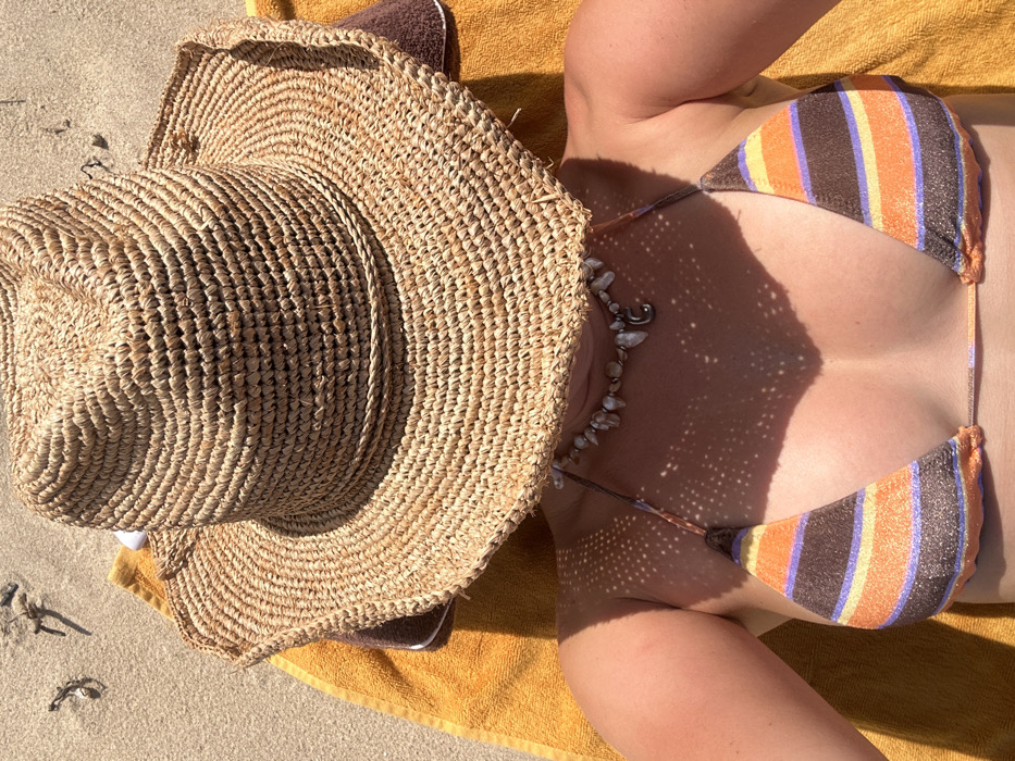 Beachgoer relaxes under clear skies at Bulli Beach