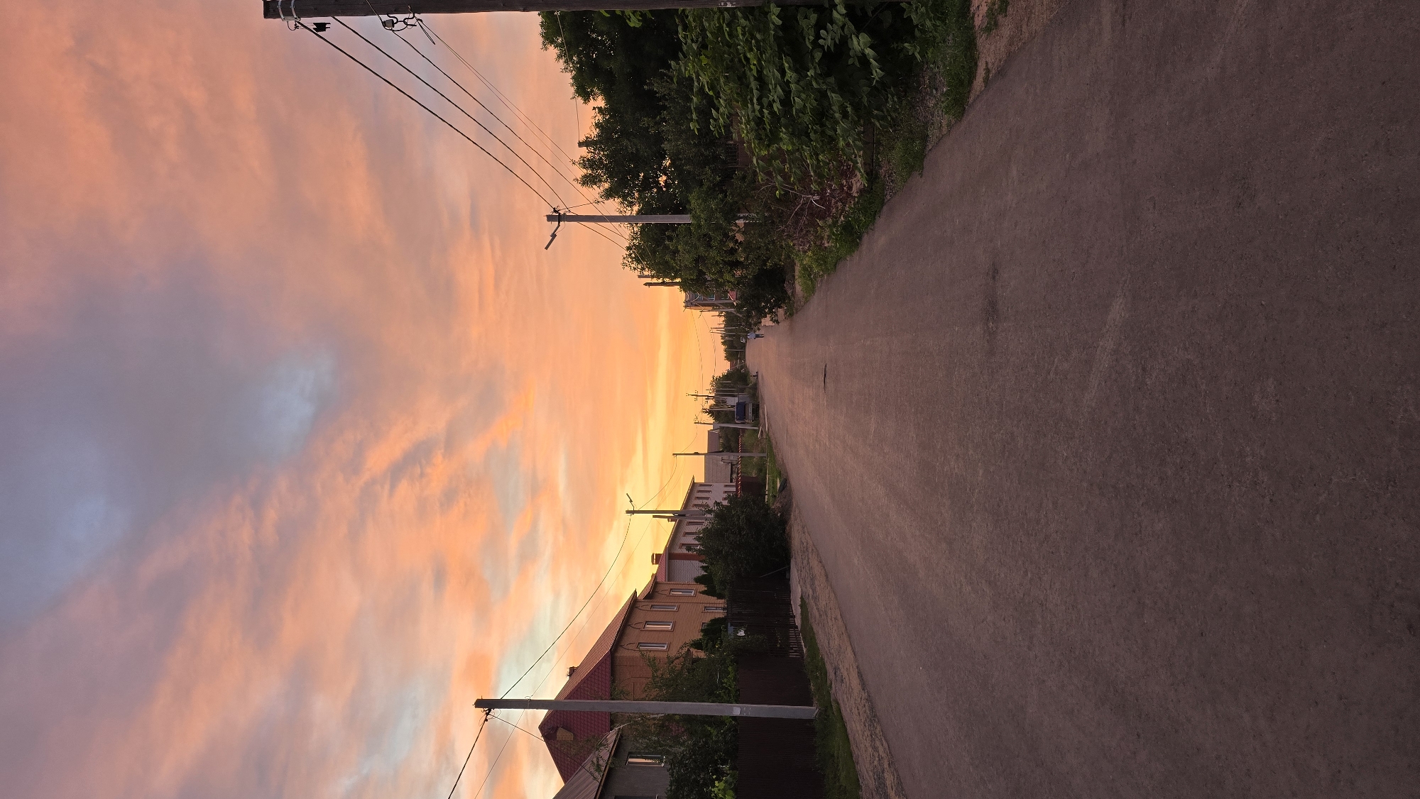 Vivid sunset sky over a residential street in Oral, Kazakhstan