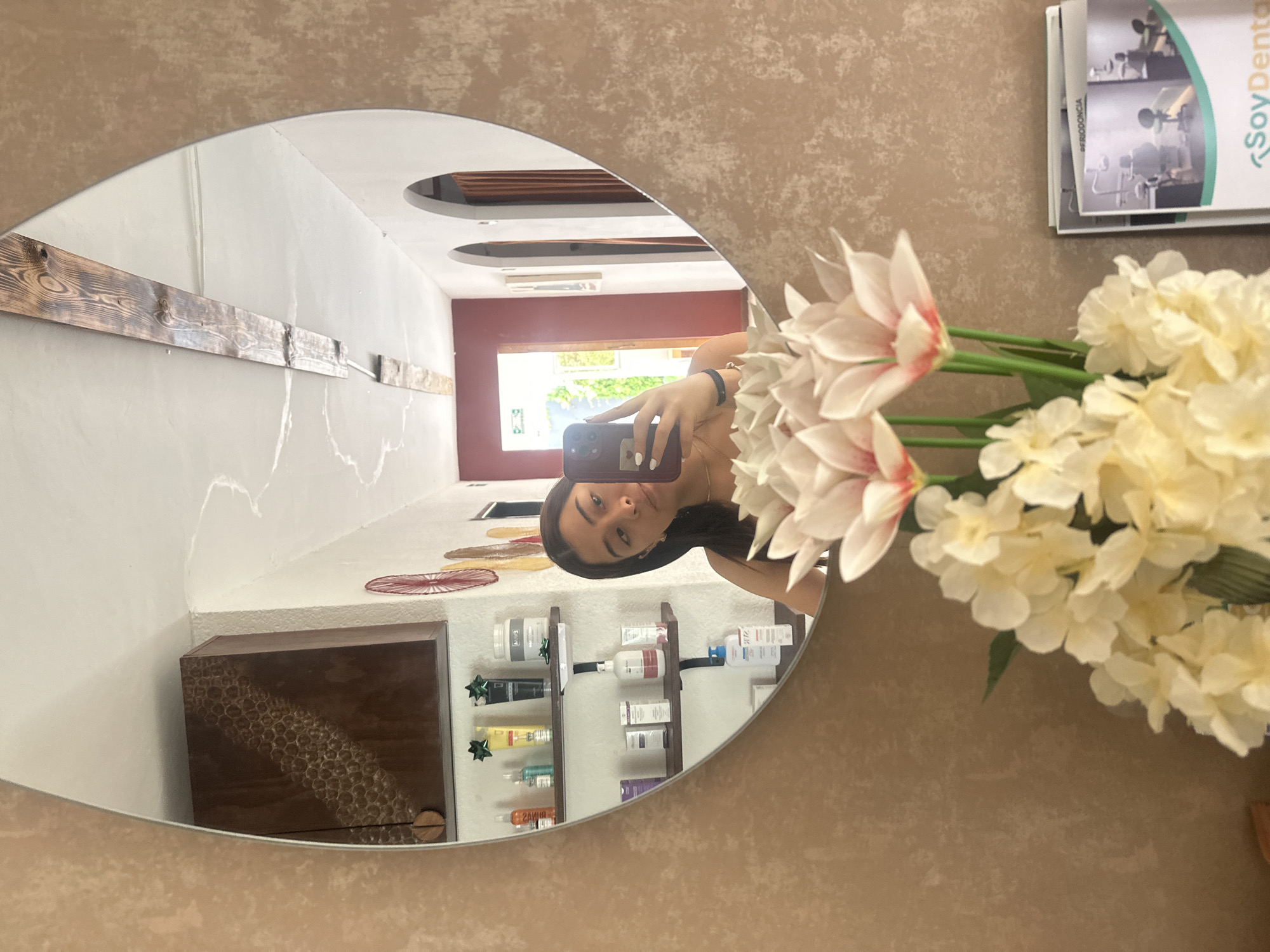 Woman takes mirror selfie in decorated Puebla home