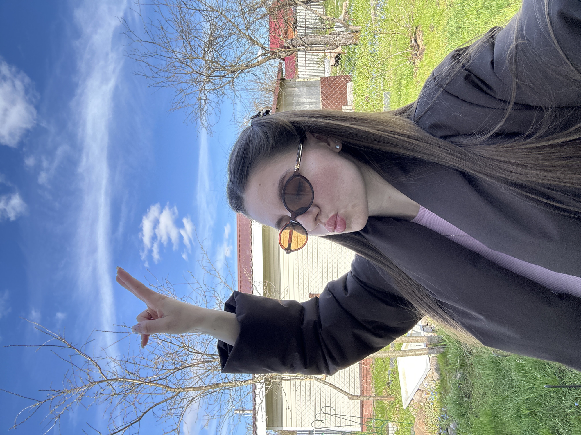 Woman poses for photos outside home in Klin, Russia
