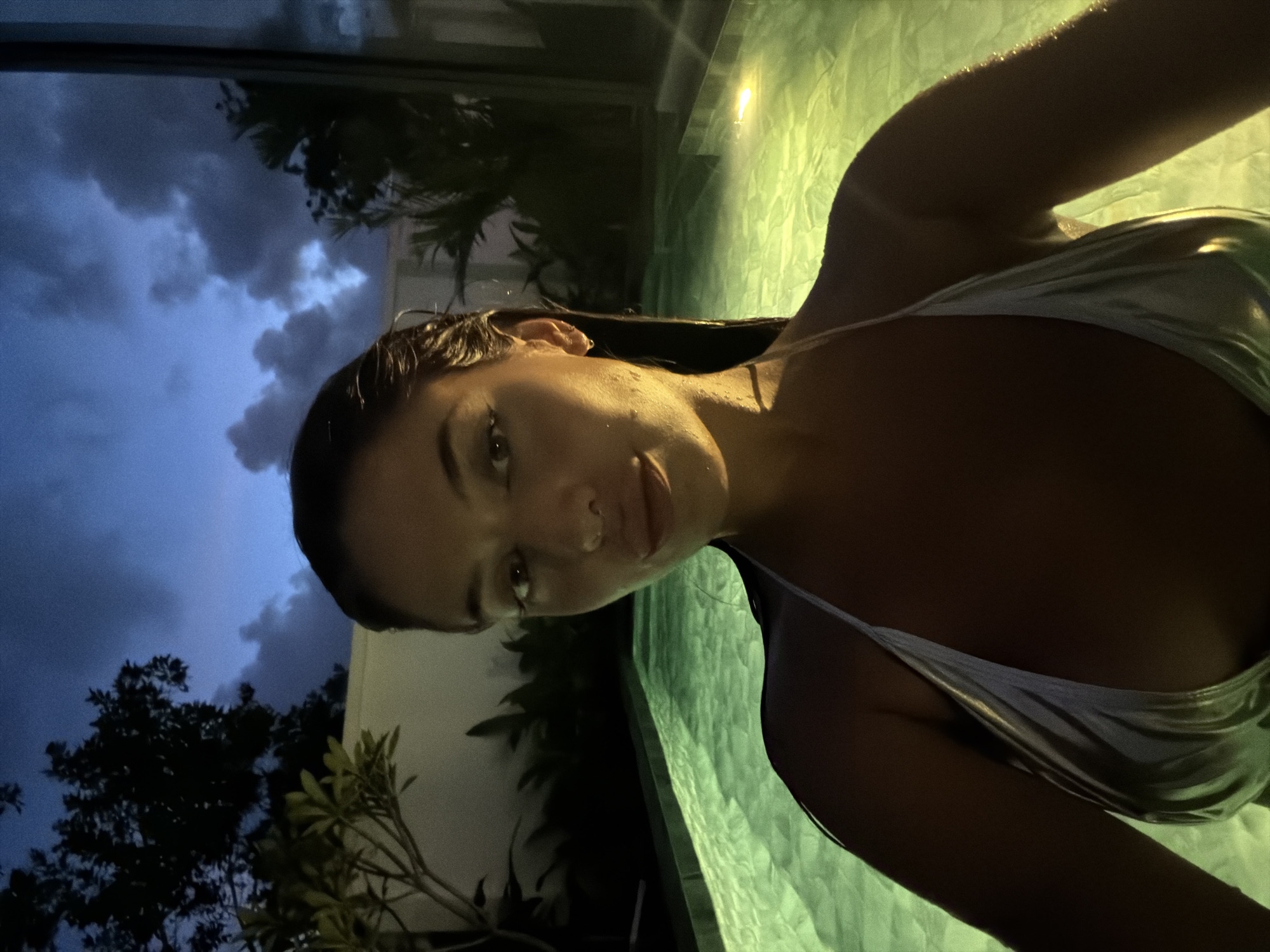 Green-lit pool night swim in Choeng Thale, Phuket