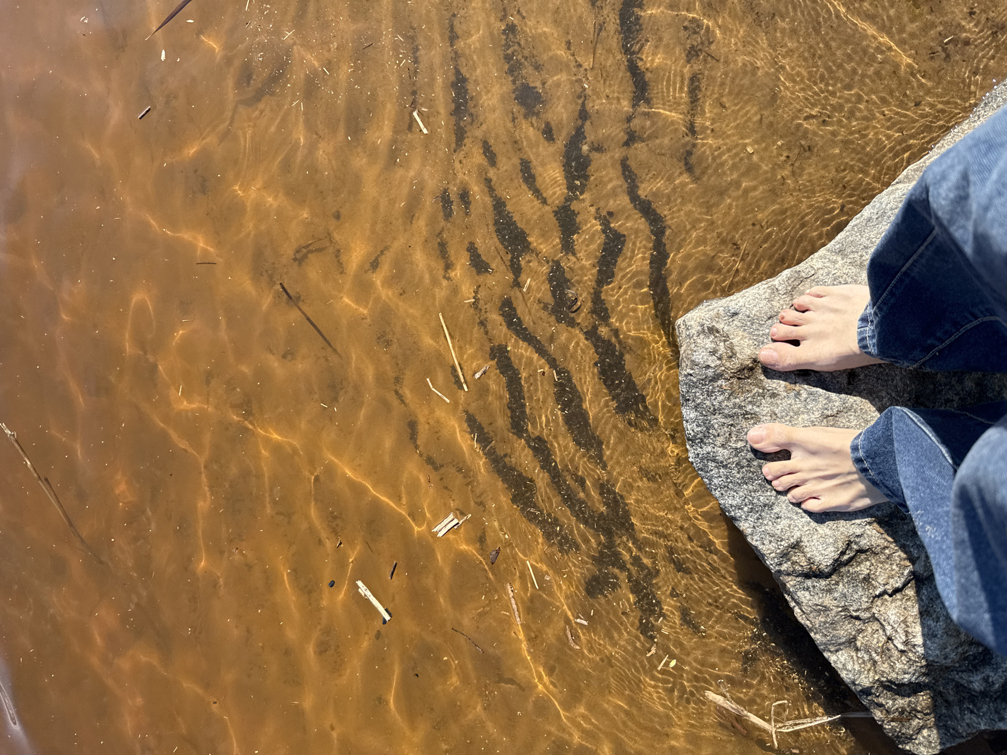 Child plays at sandy beach in Rusanovo, Russia