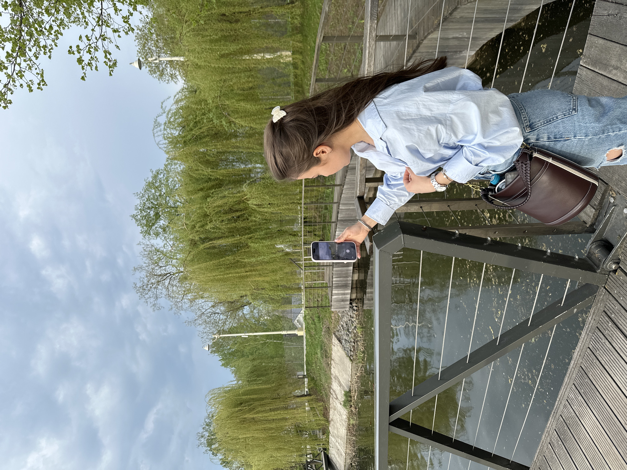 Woman photographed on wooden boardwalk over water in Moscow