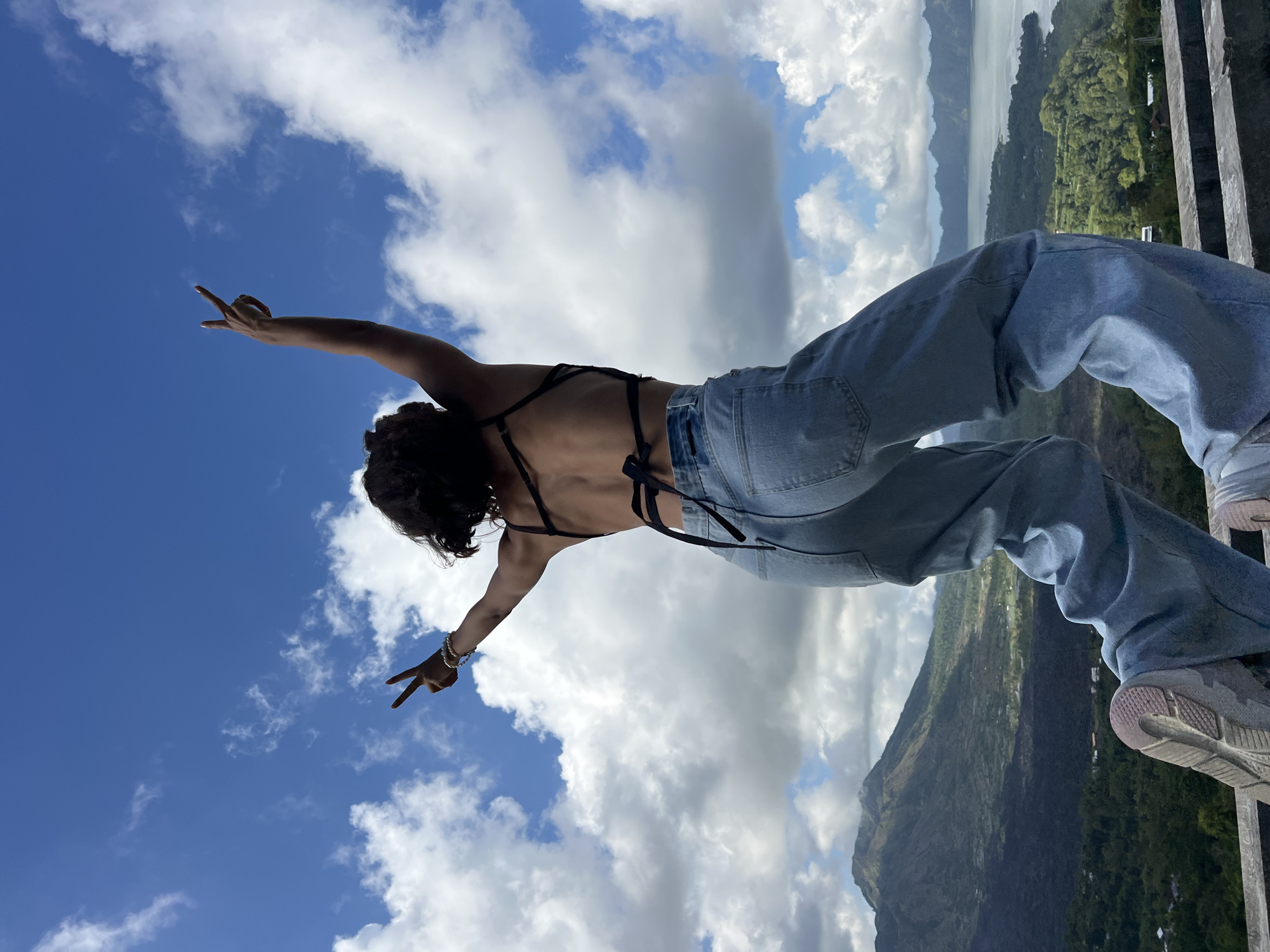 Tourist enjoys morning coffee and photos at Kintamani volcano overlook