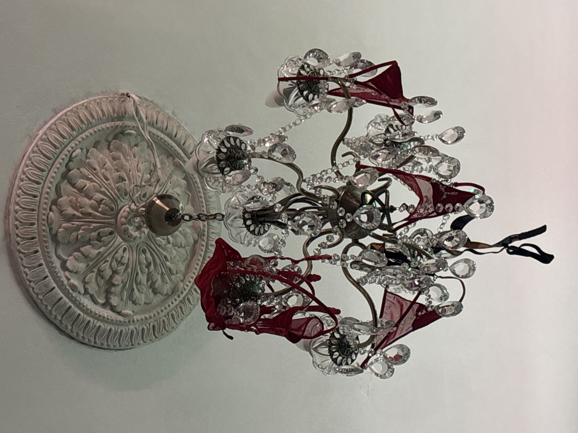 Crystal chandelier dressed in red ribbons, Saint Petersburg interior