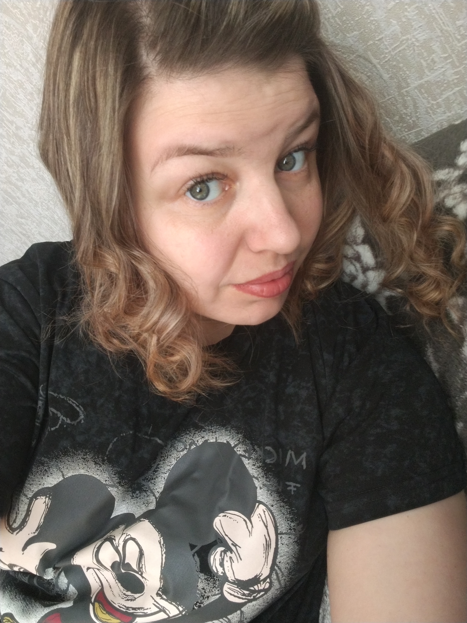 Woman photographs herself in Mickey Mouse shirt in Yaroslavl