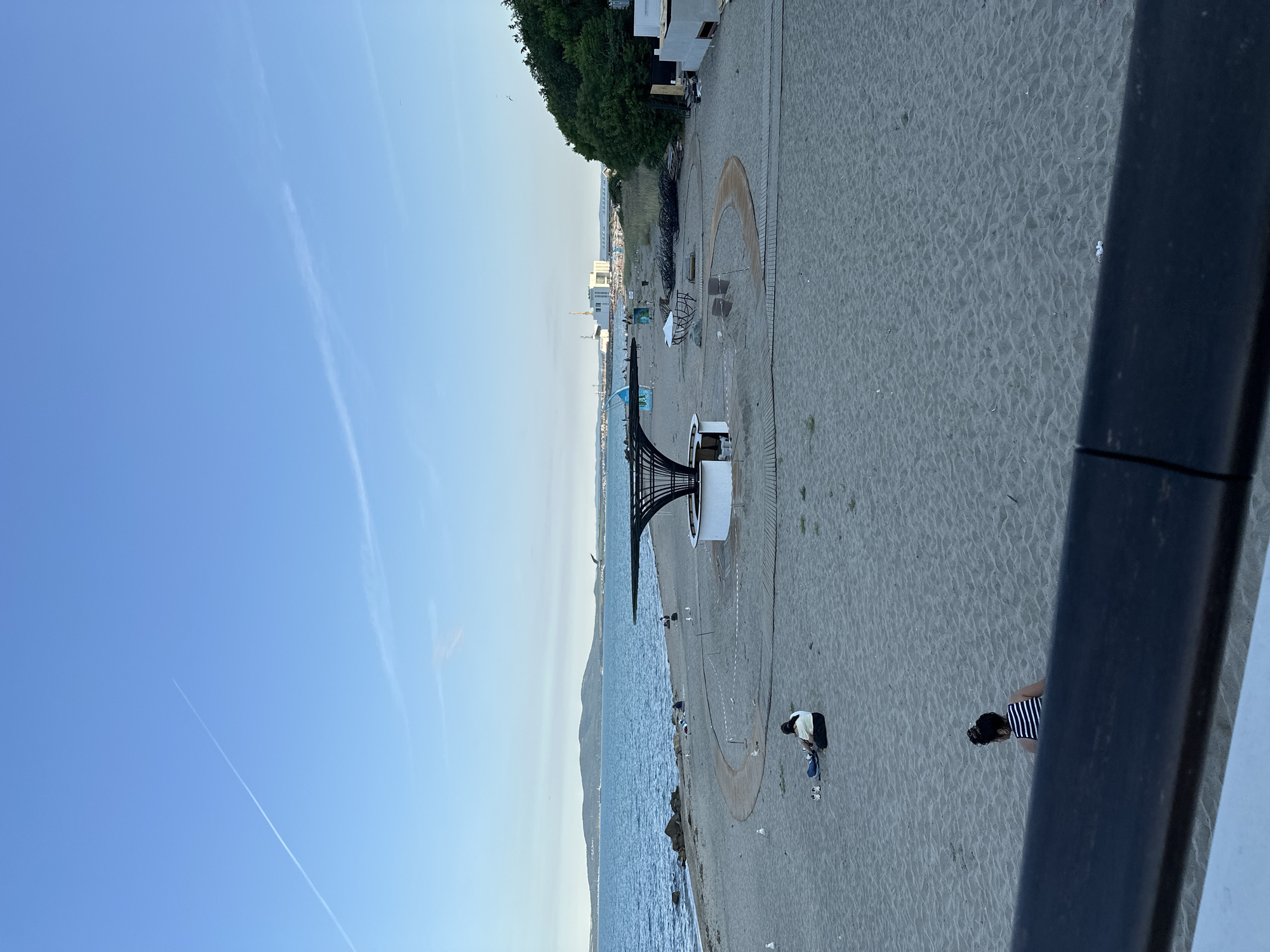 Afternoon at a coastal resort with pier, beach, and waterfront dining