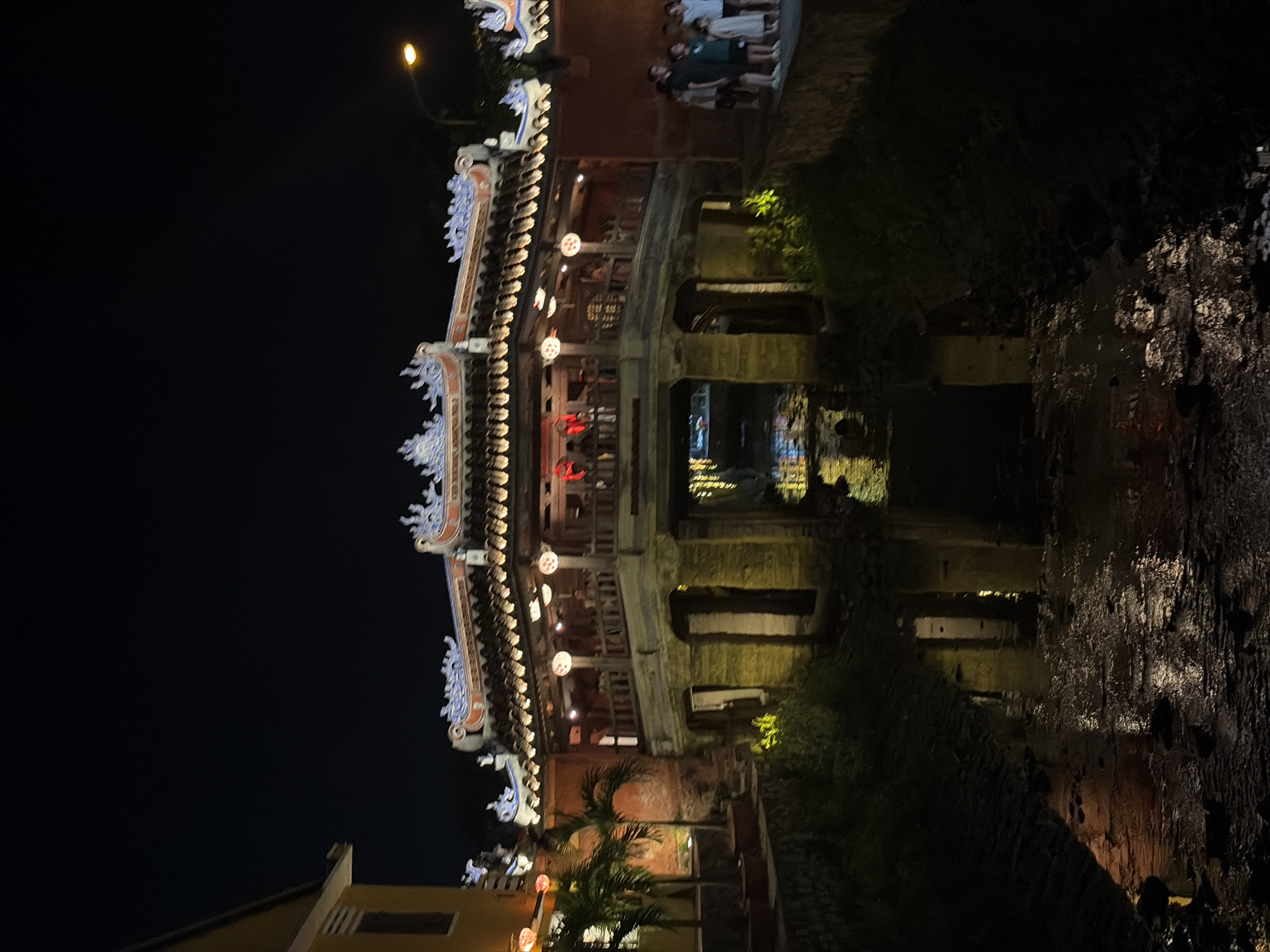Evening scenes documented in historic Hội An featuring lanterns, bridge
