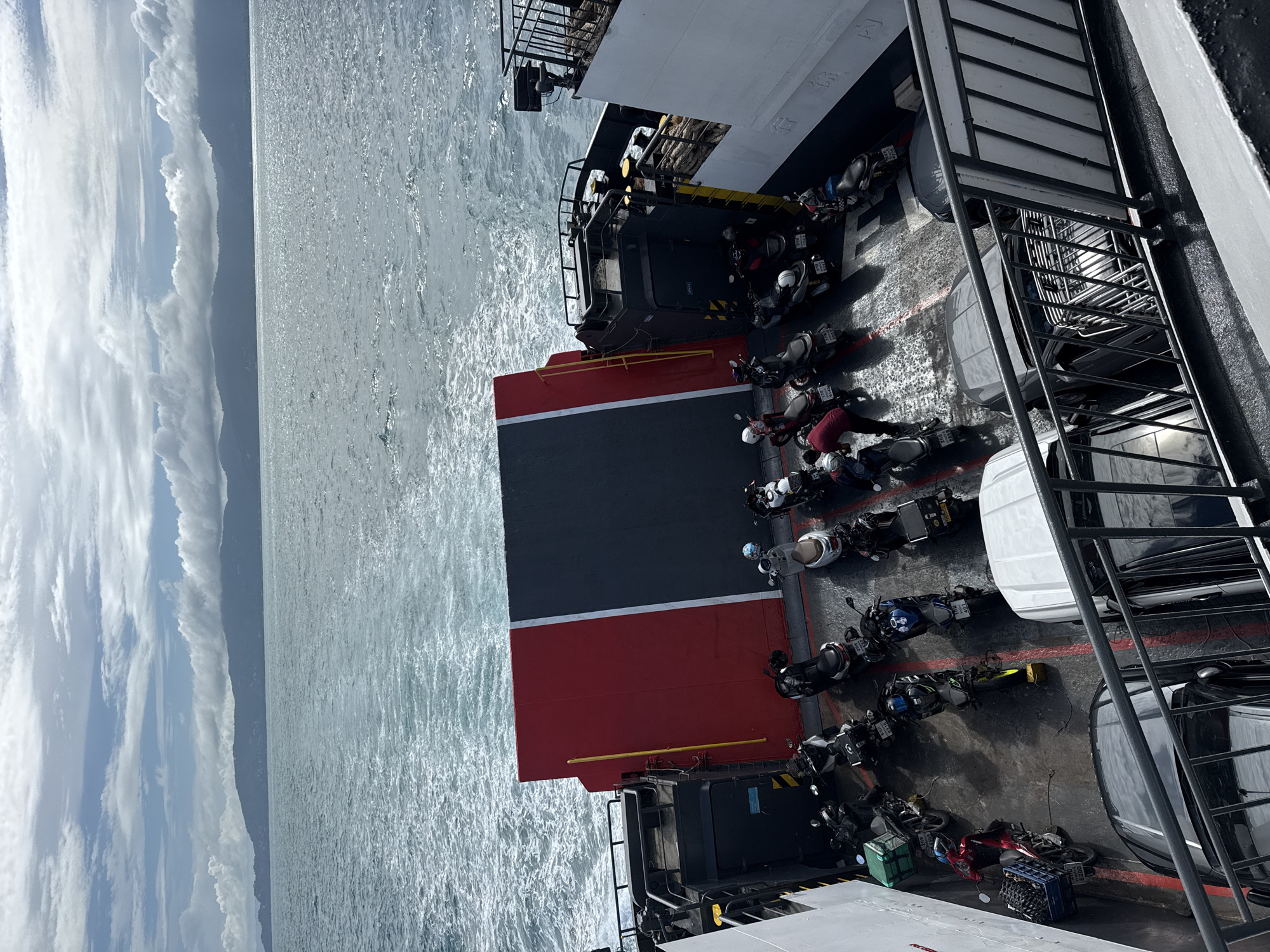 Ferry crossing through Thai island waters, deck loaded with bikes