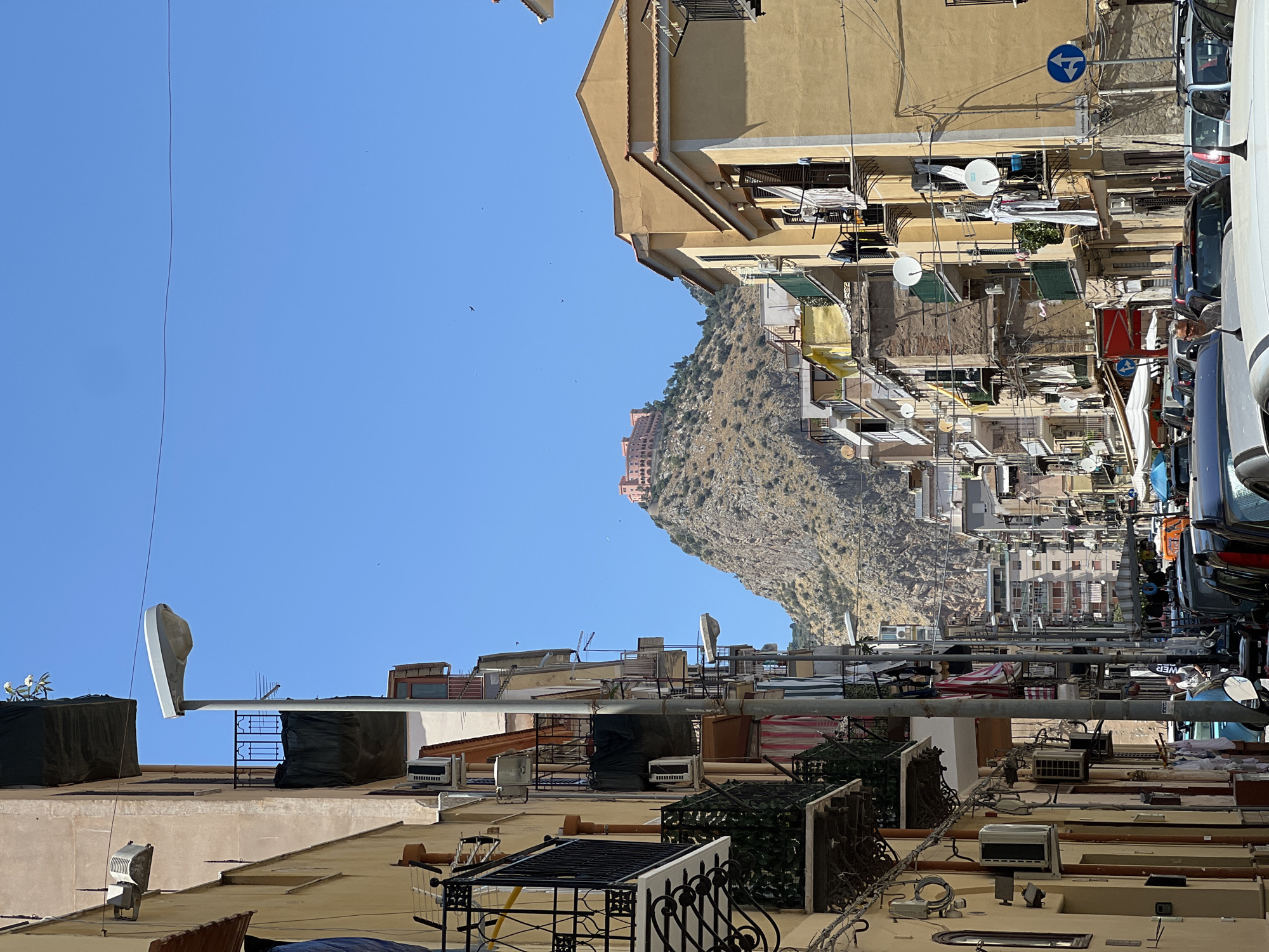 Palermo's dense rooftops and rocky hillside, upside down.