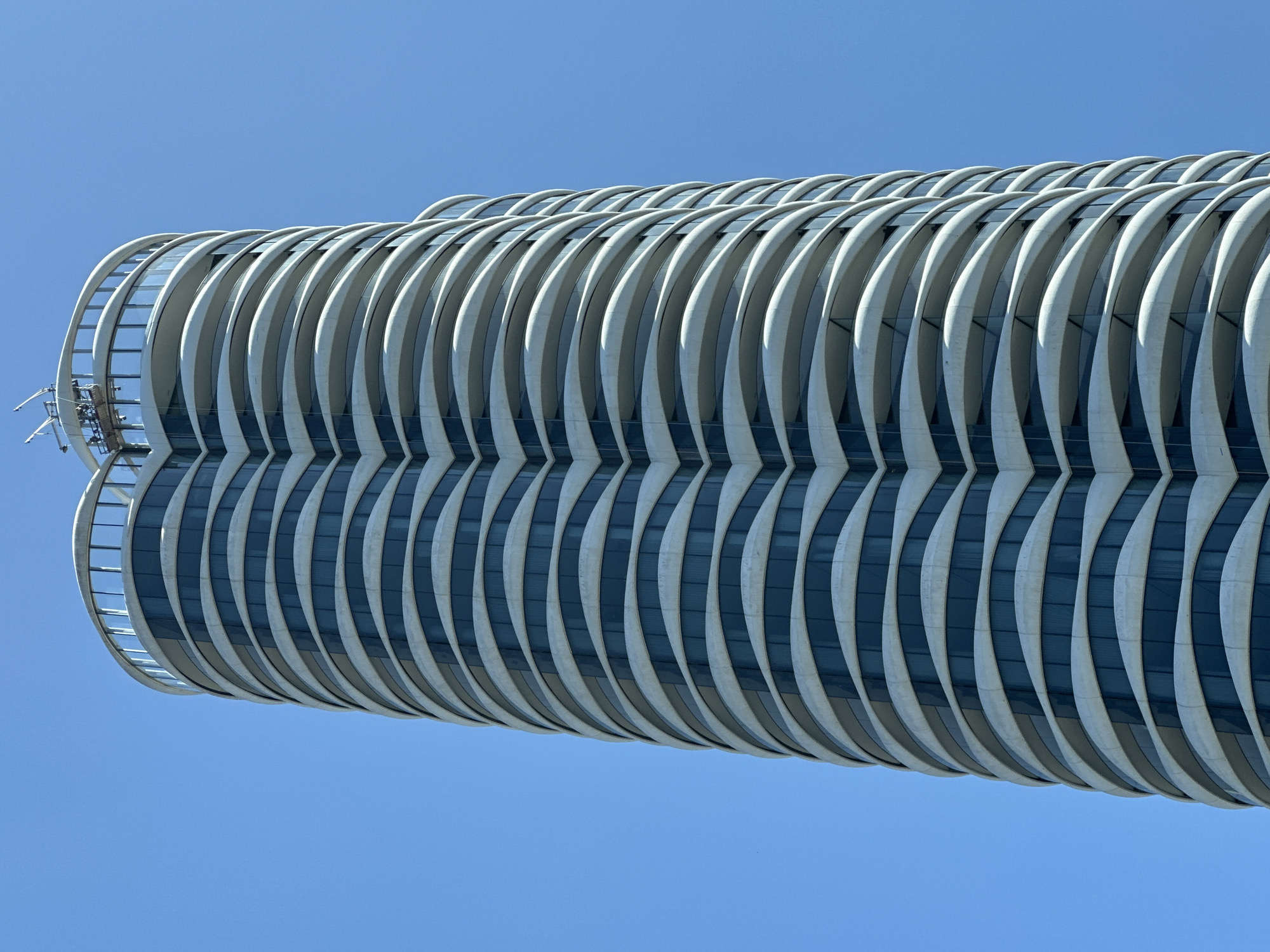 Wavy glass skyscraper stands out against Vancouver's blue sky